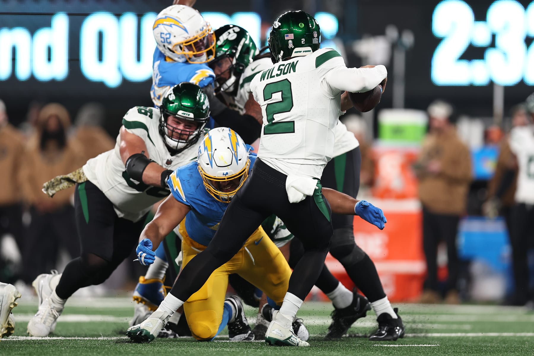 EAST RUTHERFORD, NEW JERSEY - NOVEMBER 06: Tuli Tuipulotu #45 of the Los Angeles Chargers sacks Zach Wilson #2 of the New York Jets during the second quarter at MetLife Stadium on November 06, 2023 in East Rutherford, New Jersey. (Photo by Dustin Satloff/Getty Images)