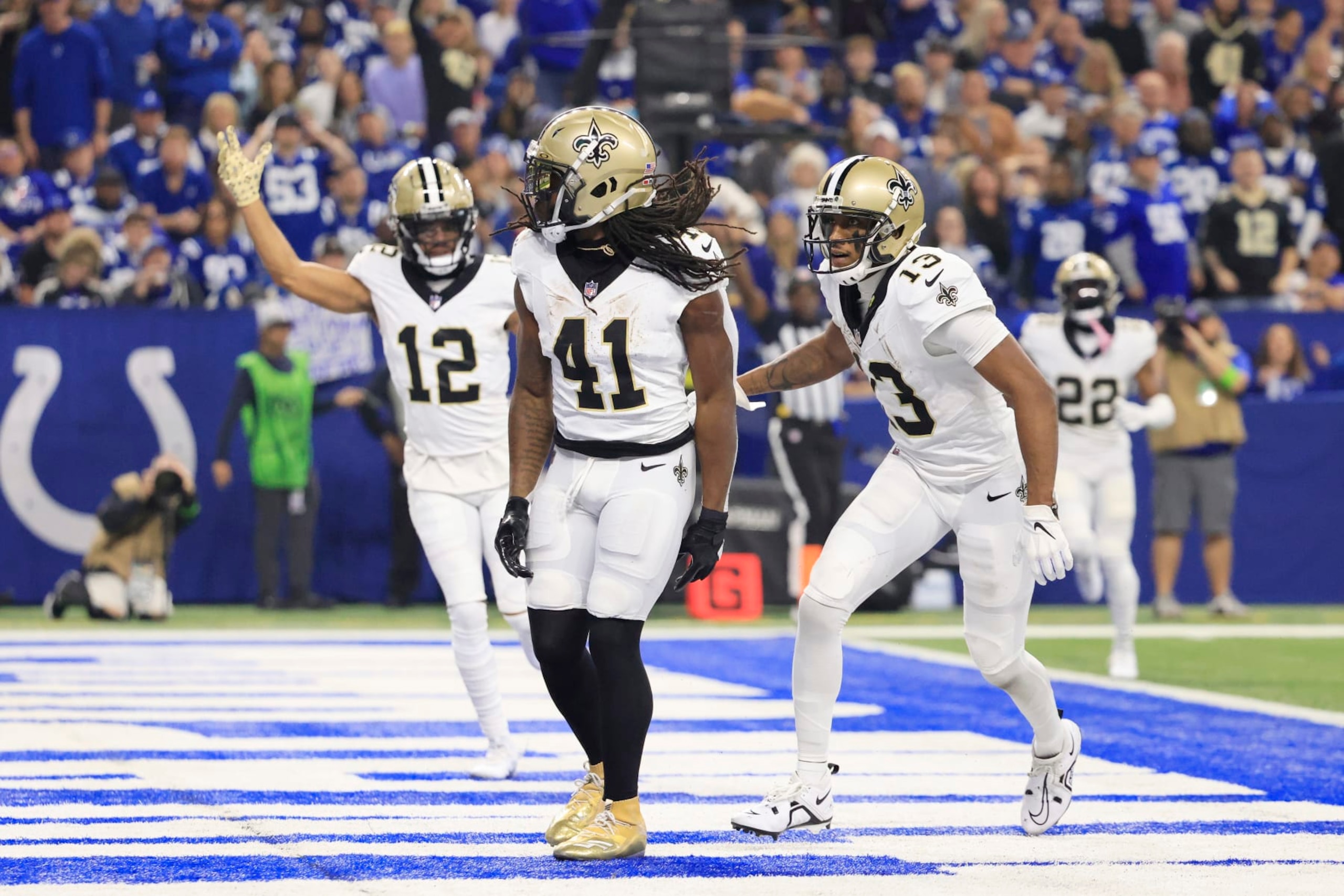 INDIANAPOLIS, INDIANA - OCTOBER 29: Chris Olave #12 of the New Orleans Saints, Alvin Kamara #41 of the New Orleans Saints and Michael Thomas #13 of the New Orleans Saints celebrate  after Kamara's receiving touchdown during the first quarter at Lucas Oil Stadium on October 29, 2023 in Indianapolis, Indiana. (Photo by Justin Casterline/Getty Images)