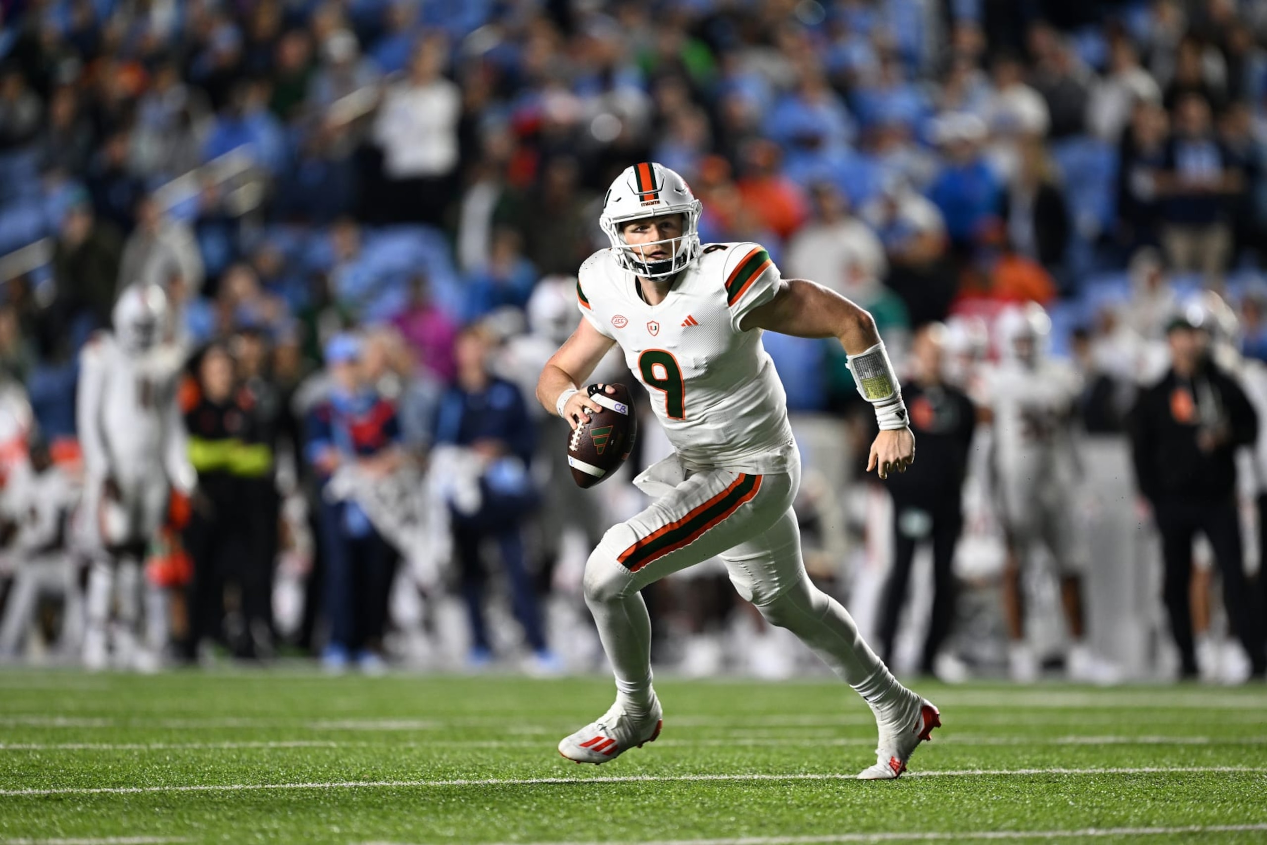 CHAPEL HILL, NORTH CAROLINA - OCTOBER 14: Tyler Van Dyke #9 of the Miami Hurricanes rolls out against the North Carolina Tar Heels during their game at Kenan Memorial Stadium on October 14, 2023 in Chapel Hill, North Carolina. The Tar Heels won 41-31. (Photo by Grant Halverson/Getty Images) CHAPEL HILL, NORTH CAROLINA - OCTOBER 14: Tyler Van Dyke #9 of the Miami Hurricanes rolls out against the North Carolina Tar Heels during their game at Kenan Memorial Stadium on October 14, 2023 in Chapel Hill, North Carolina. The Tar Heels won 41-31. (Photo by Grant Halverson/Getty Images)