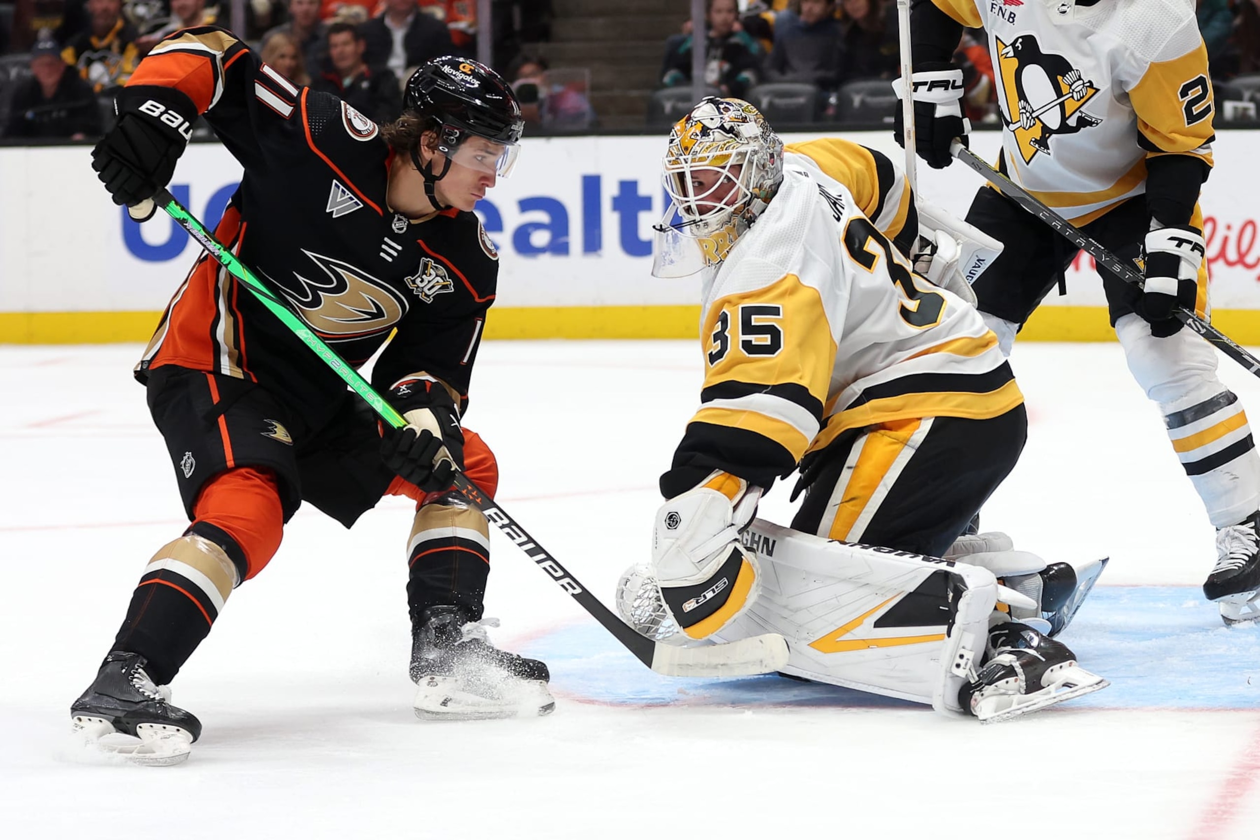 ANAHEIM, CALIFORNIA - NOVEMBER 07: Trevor Zegras #11 of the Anaheim Ducks collides with Tristan Jarry #35 of the Pittsburgh Penguins during the second period of a game at Honda Center on November 07, 2023 in Anaheim, California. (Photo by Sean M. Haffey/Getty Images)