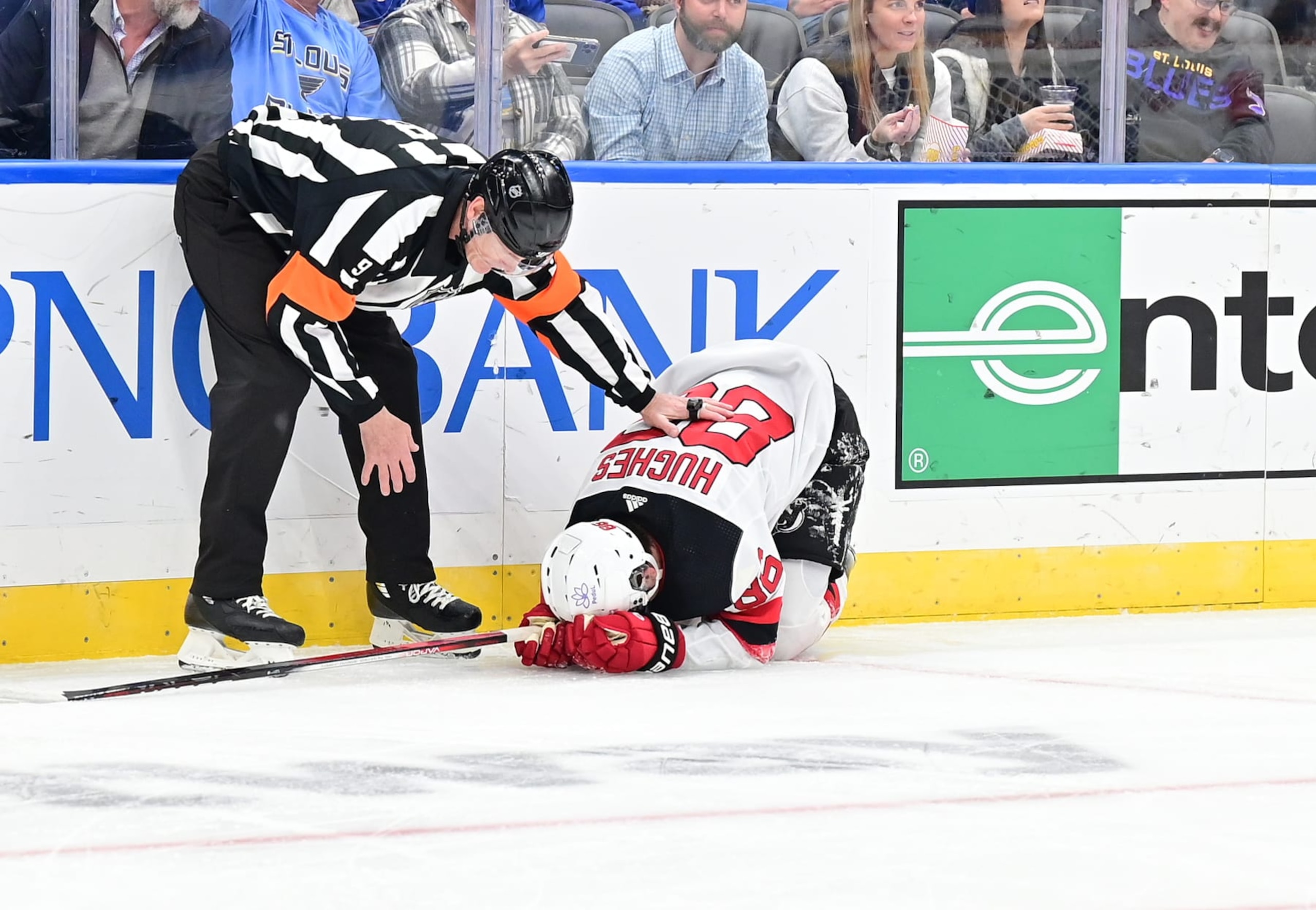 ST. LOUIS, MO - NOVEMBER 03: An official checks on New Jersey Devils center Jack Hughes (86) after he hit the back boards after taking a shot on goal during a NHL game between the New Jersey Devils and the St. Louis Blues on November 03, 2023, at Enterprise Center in St. Louis, MO. (Photo by Keith Gillett/Icon Sportswire via Getty Images)