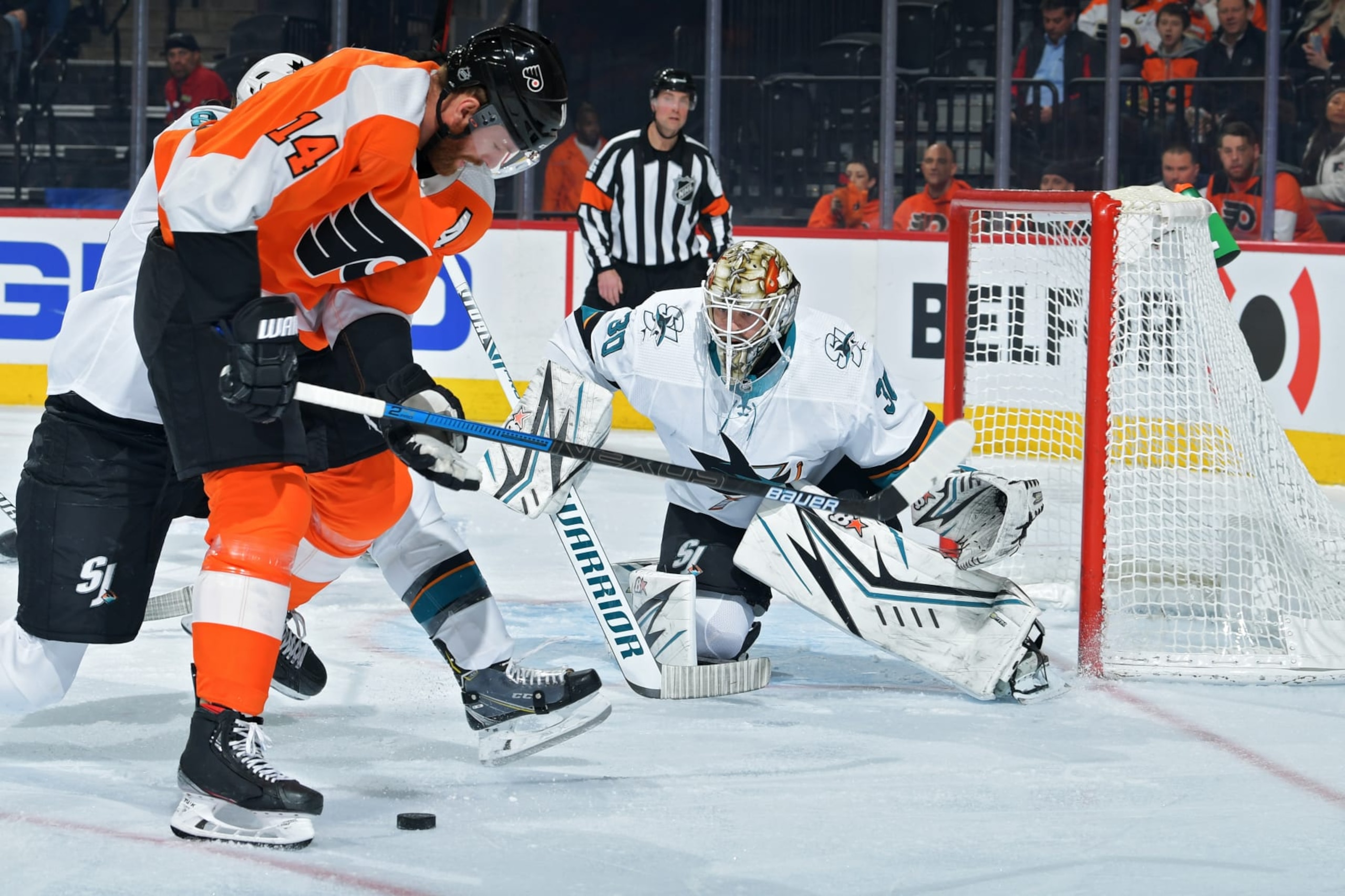 PHILADELPHIA, PA - FEBRUARY 25: Aaron Dell #30 of the San Jose Sharks looks to make a save as Sean Couturier #14 of the Philadelphia Flyers tries to get a shot off in the first period at Wells Fargo Center on February 25, 2020 in Philadelphia, Pennsylvania. (Photo by Drew Hallowell/Getty Images)