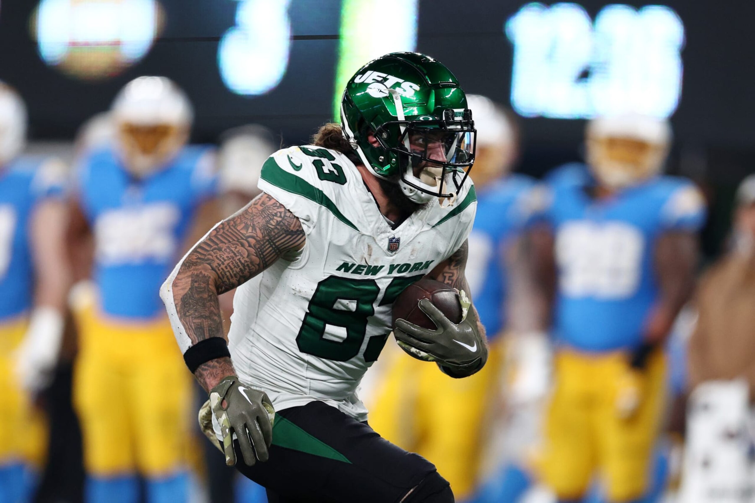 EAST RUTHERFORD, NEW JERSEY - NOVEMBER 06: Tyler Conklin #83 of the New York Jets runs with the ball during the second half against the Los Angeles Chargers at MetLife Stadium on November 06, 2023 in East Rutherford, New Jersey. (Photo by Elsa/Getty Images)
