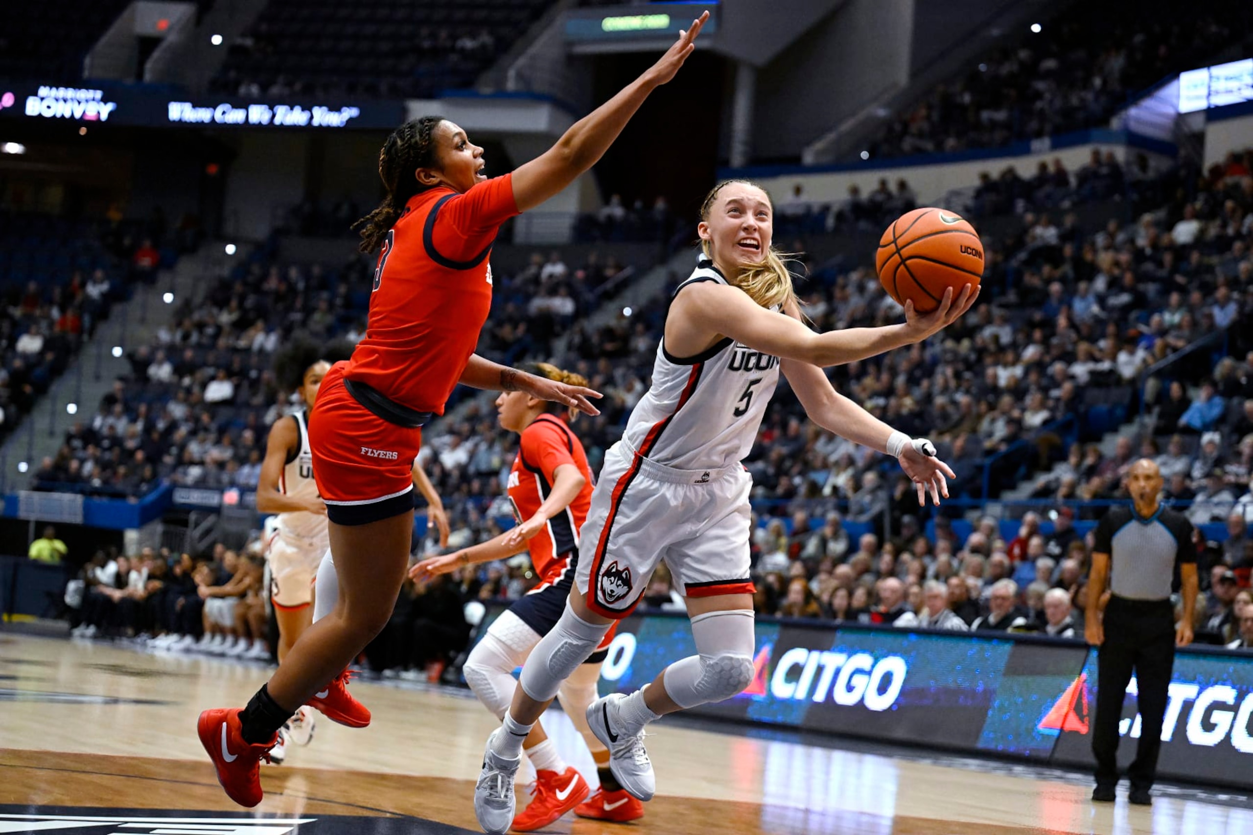 UConn guard Paige Bueckers shoots as Dayton guard Anyssa Jones defends in the first half of an NCAA college basketball game, Wednesday, Nov. 8, 2023, in Storrs, Conn. (AP Photo/Jessica Hill)