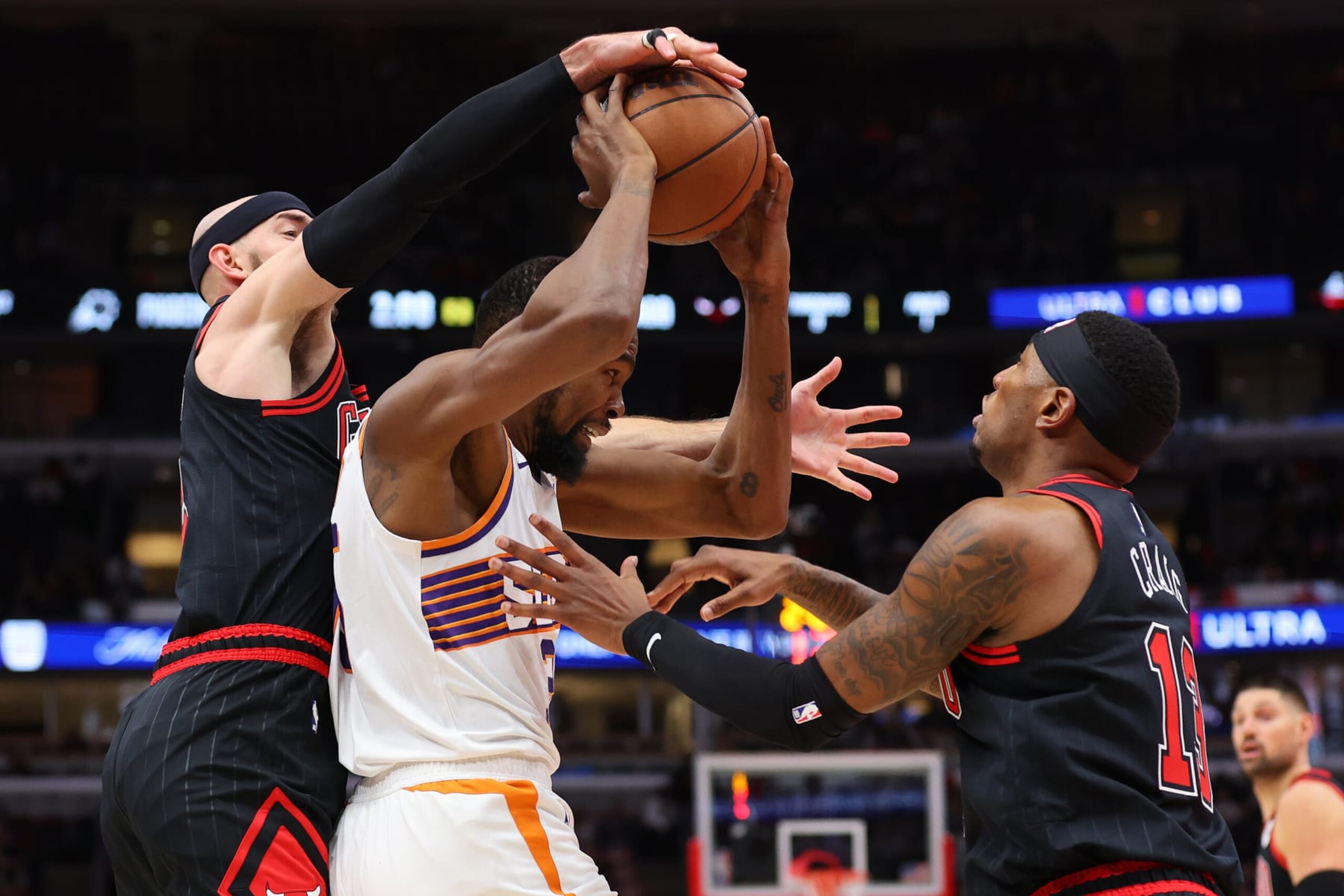CHICAGO, ILLINOIS - NOVEMBER 08: Kevin Durant #35 of the Phoenix Suns is defended by Alex Caruso #6 and Torrey Craig #13 of the Chicago Bulls during the first half at the United Center on November 08, 2023 in Chicago, Illinois. NOTE TO USER: User expressly acknowledges and agrees that, by downloading and or using this photograph, User is consenting to the terms and conditions of the Getty Images License Agreement.  (Photo by Michael Reaves/Getty Images)