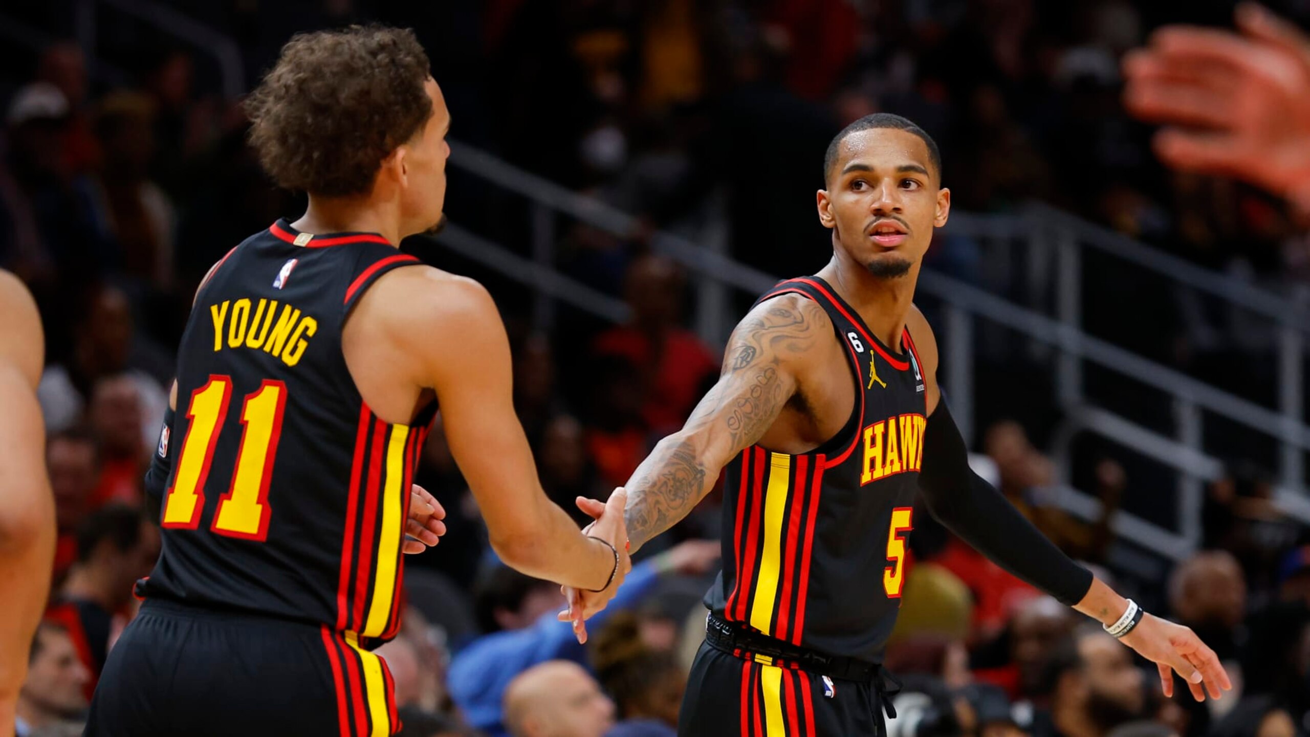 ATLANTA, GA - JANUARY 20: Trae Young #11 reacts with Dejounte Murray #5 of the Atlanta Hawks during the second half against the New York Knicks at State Farm Arena on January 20, 2023 in Atlanta, Georgia. NOTE TO USER: User expressly acknowledges and agrees that, by downloading and or using this photograph, User is consenting to the terms and conditions of the Getty Images License Agreement. (Photo by Todd Kirkland/Getty Images)