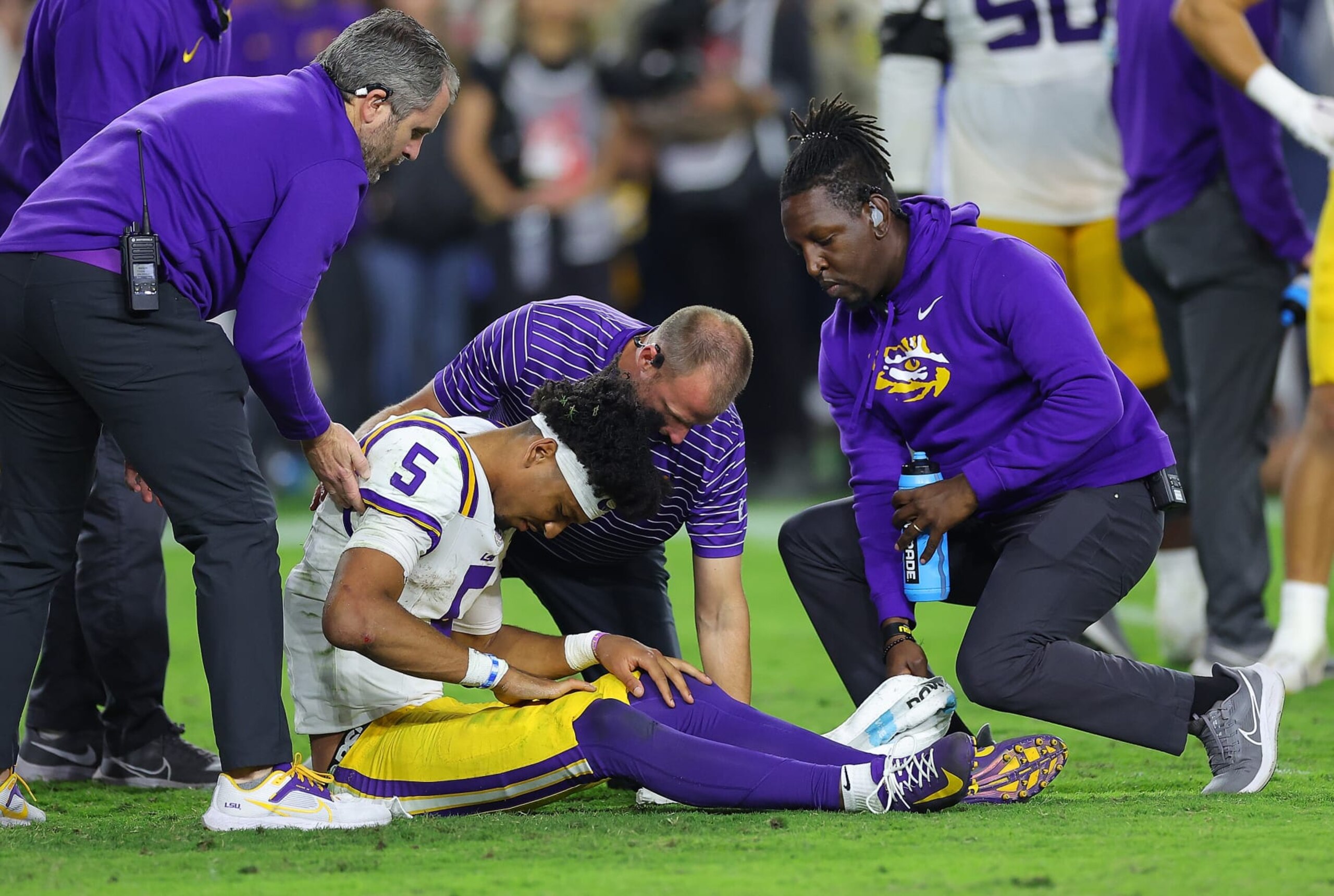 TUSCALOOSA, ALABAMA - NOVEMBER 04: Jayden Daniels #5 of the LSU Tigers is treated by training personnel after he was hit by the Alabama Crimson Tide during the fourth quarter at Bryant-Denny Stadium on November 04, 2023 in Tuscaloosa, Alabama. After an official review, the Crimson Tide were assessed a penalty for roughing the passer. (Photo by Kevin C. Cox/Getty Images) TUSCALOOSA, ALABAMA - NOVEMBER 04: Jayden Daniels #5 of the LSU Tigers is treated by training personnel after he was hit by the Alabama Crimson Tide during the fourth quarter at Bryant-Denny Stadium on November 04, 2023 in Tuscaloosa, Alabama. After an official review, the Crimson Tide were assessed a penalty for roughing the passer. (Photo by Kevin C. Cox/Getty Images)