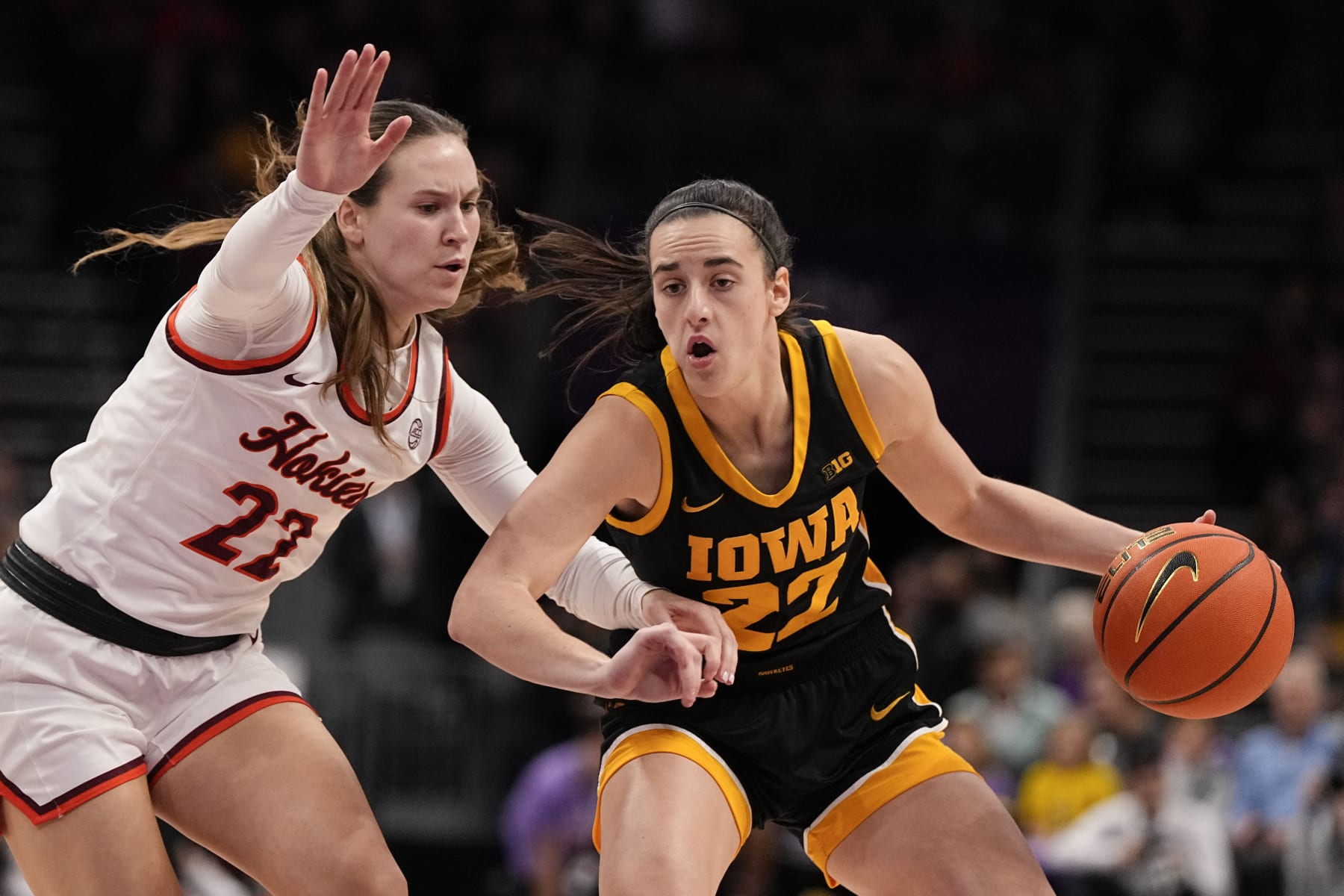 Iowa guard Caitlin Clark, right, drives to the basket past Virginia Tech guard Cayla King, left, during the first half of an NCAA women's college basketball game Thursday, Nov. 9, 2023, in Charlotte, N.C. (AP Photo/Chris Carlson)