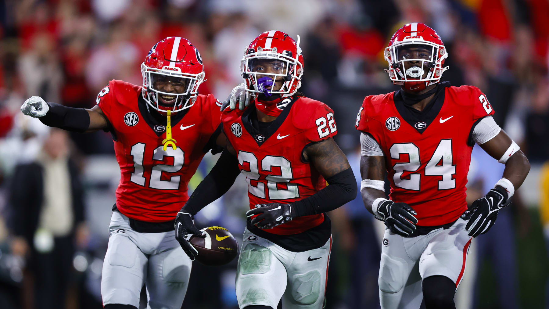 ATHENS, GEORGIA - NOVEMBER 4: Javon Bullard #22 of the Georgia Bulldogs reacts after his interception with Julian Humphrey #12 and Malaki Starks #24 during the fourth quarter against the Missouri Tigers at Sanford Stadium on November 4, 2023 in Athens, Georgia. (Photo by Todd Kirkland/Getty Images)