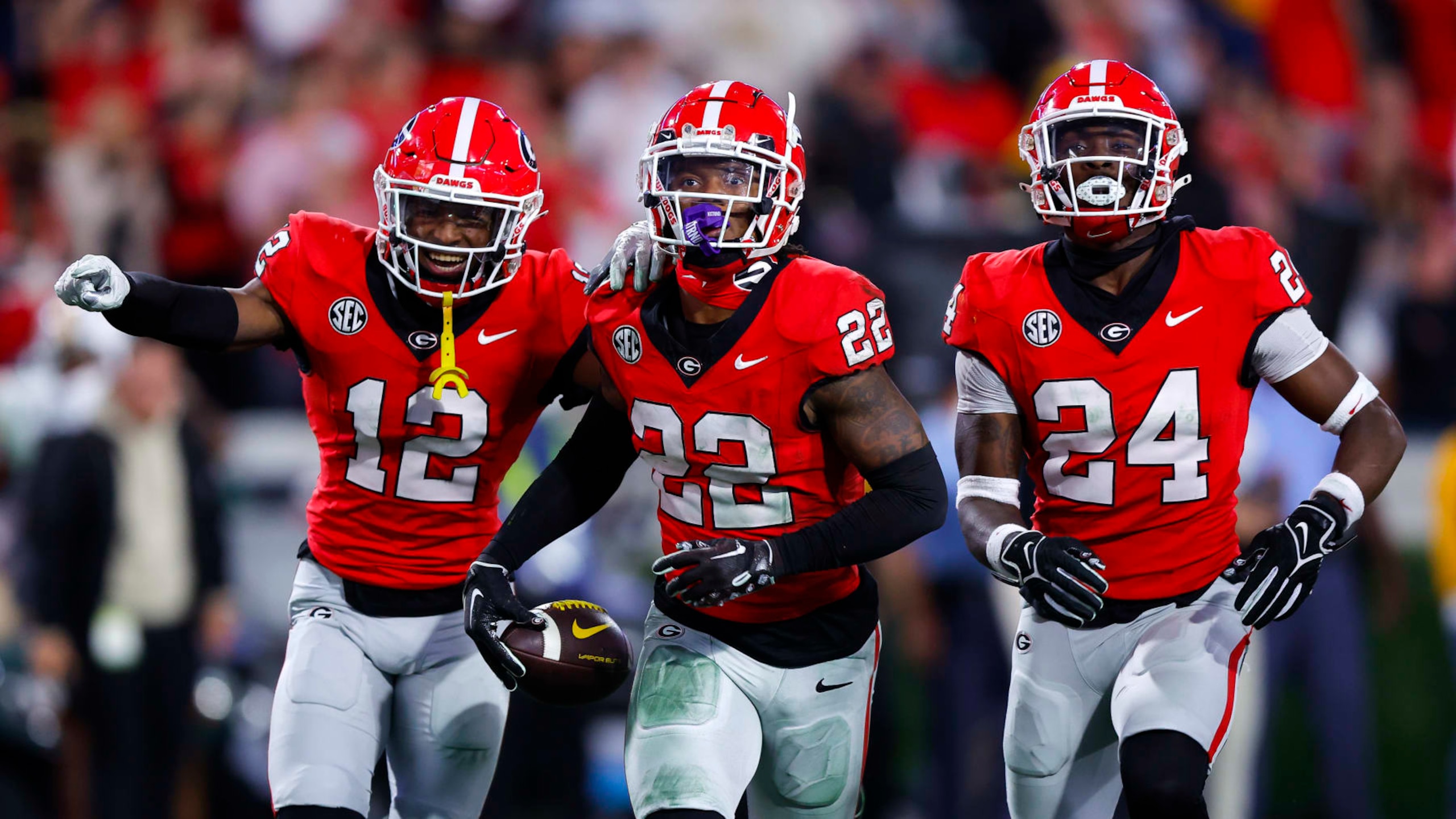 ATHENS, GEORGIA - NOVEMBER 4: Javon Bullard #22 of the Georgia Bulldogs reacts after his interception with Julian Humphrey #12 and Malaki Starks #24 during the fourth quarter against the Missouri Tigers at Sanford Stadium on November 4, 2023 in Athens, Georgia. (Photo by Todd Kirkland/Getty Images)
