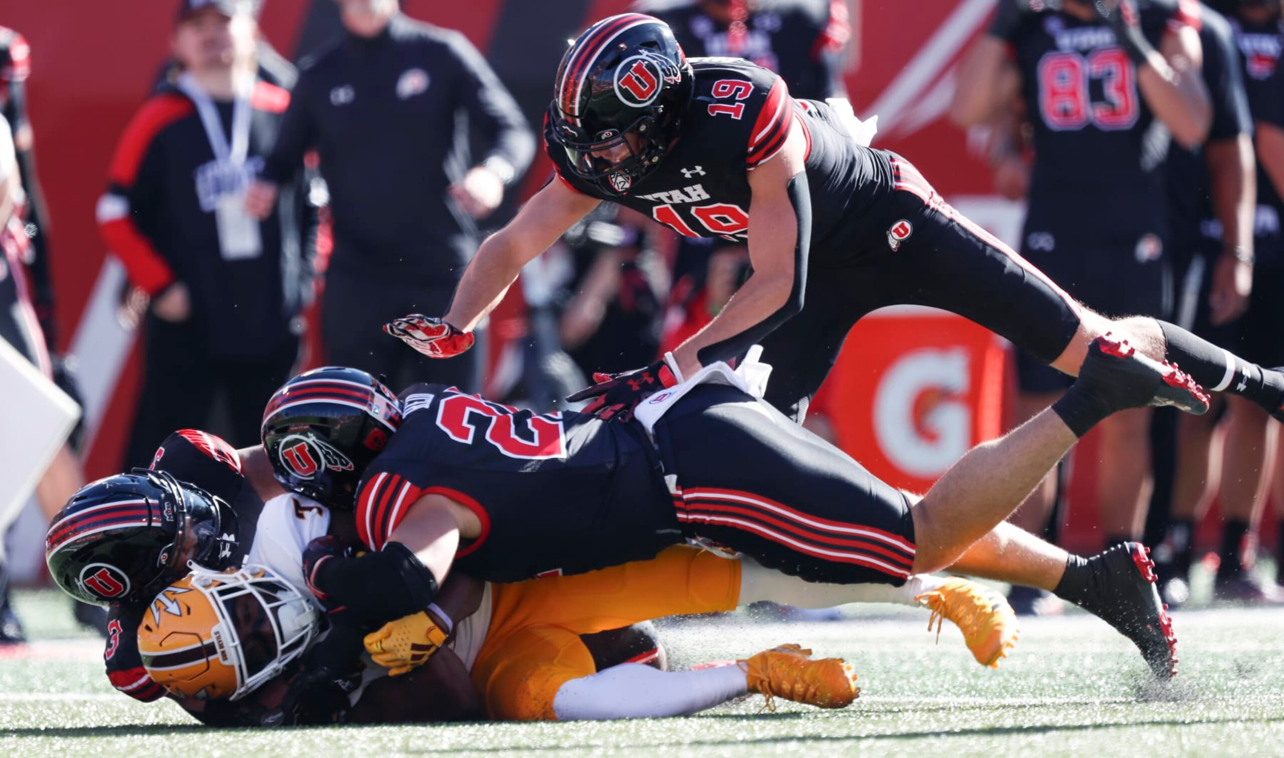 SALT LAKE CITY, UT - NOVEMBER 4:  Melquan Stovall #7 of the Arizona State Sun Devils is tackled by Levani Damuni #3, Karene Reid #21, and  Bryson Reeves #19 of the Utah Utes during the first half of their game at Rice Eccles Stadium on November 4, 2023 in Salt Lake City, Utah.  (Photo by Chris Gardner/Getty Images)