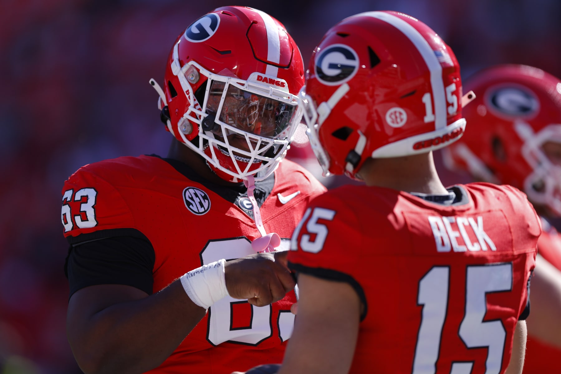 ATHENS, GEORGIA - NOVEMBER 4: Sedrick Van Pran #63 speaks with Carson Beck #15 of the Georgia Bulldogs prior to the game against the Missouri Tigers at Sanford Stadium on November 4, 2023 in Athens, Georgia. (Photo by Todd Kirkland/Getty Images)