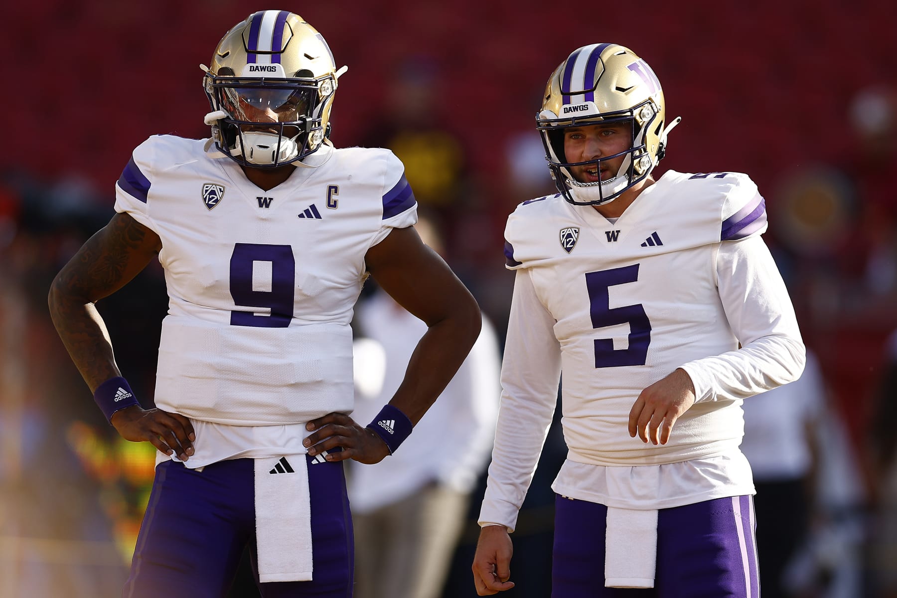 LOS ANGELES, CALIFORNIA - NOVEMBER 04:   Michael Penix Jr. #9 and Dylan Morris #5 of the Washington Huskies at United Airlines Field at the Los Angeles Memorial Coliseum on November 04, 2023 in Los Angeles, California. (Photo by Ronald Martinez/Getty Images)