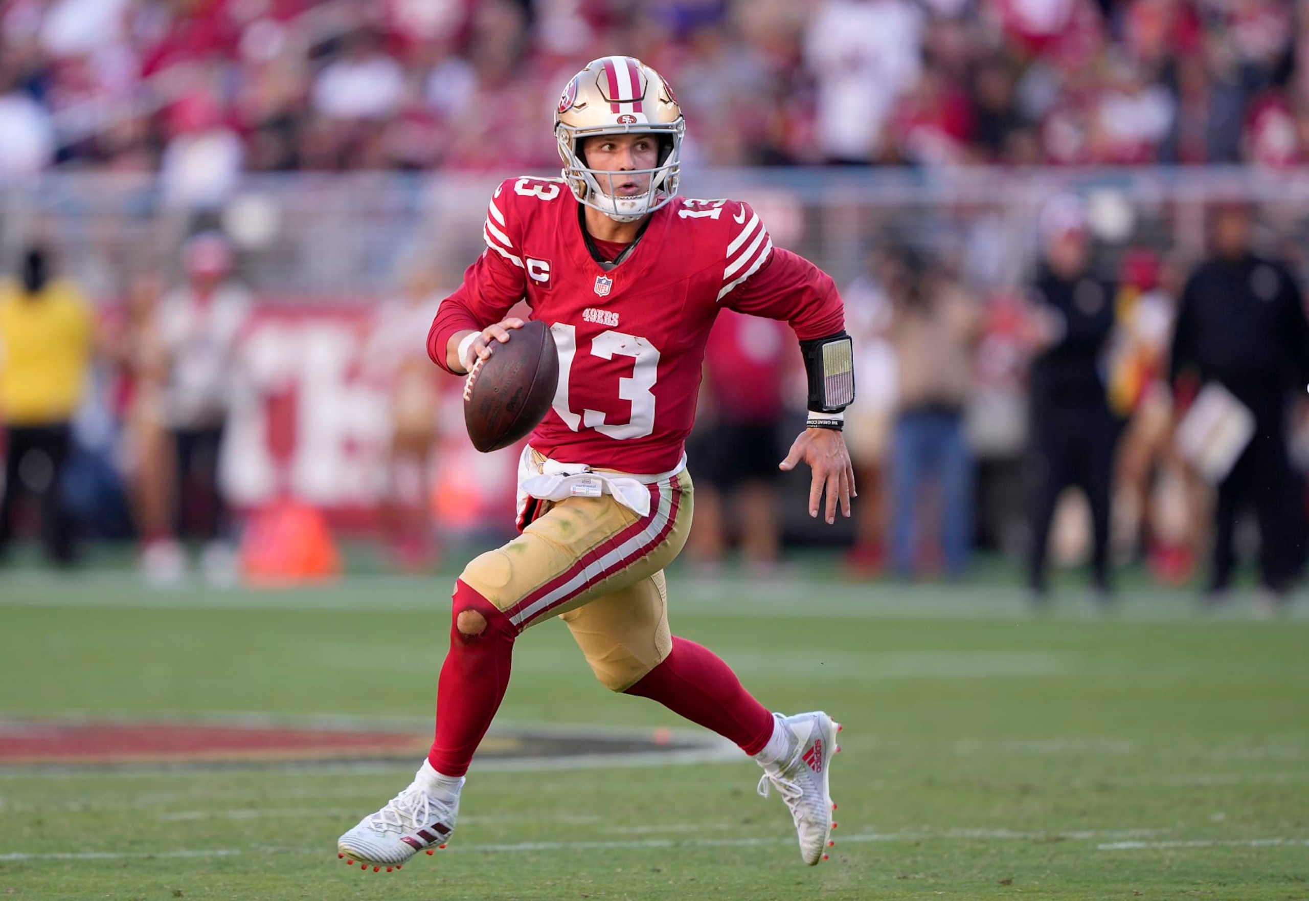 SANTA CLARA, CALIFORNIA - OCTOBER 29: Brock Purdy #13 of the San Francisco 49ers scrambles with the ball looking to pass against the Cincinnati Bengals during the fourth quarter of an NFL football game at Levi's Stadium on October 29, 2023 in Santa Clara, California. (Photo by Thearon W. Henderson/Getty Images)