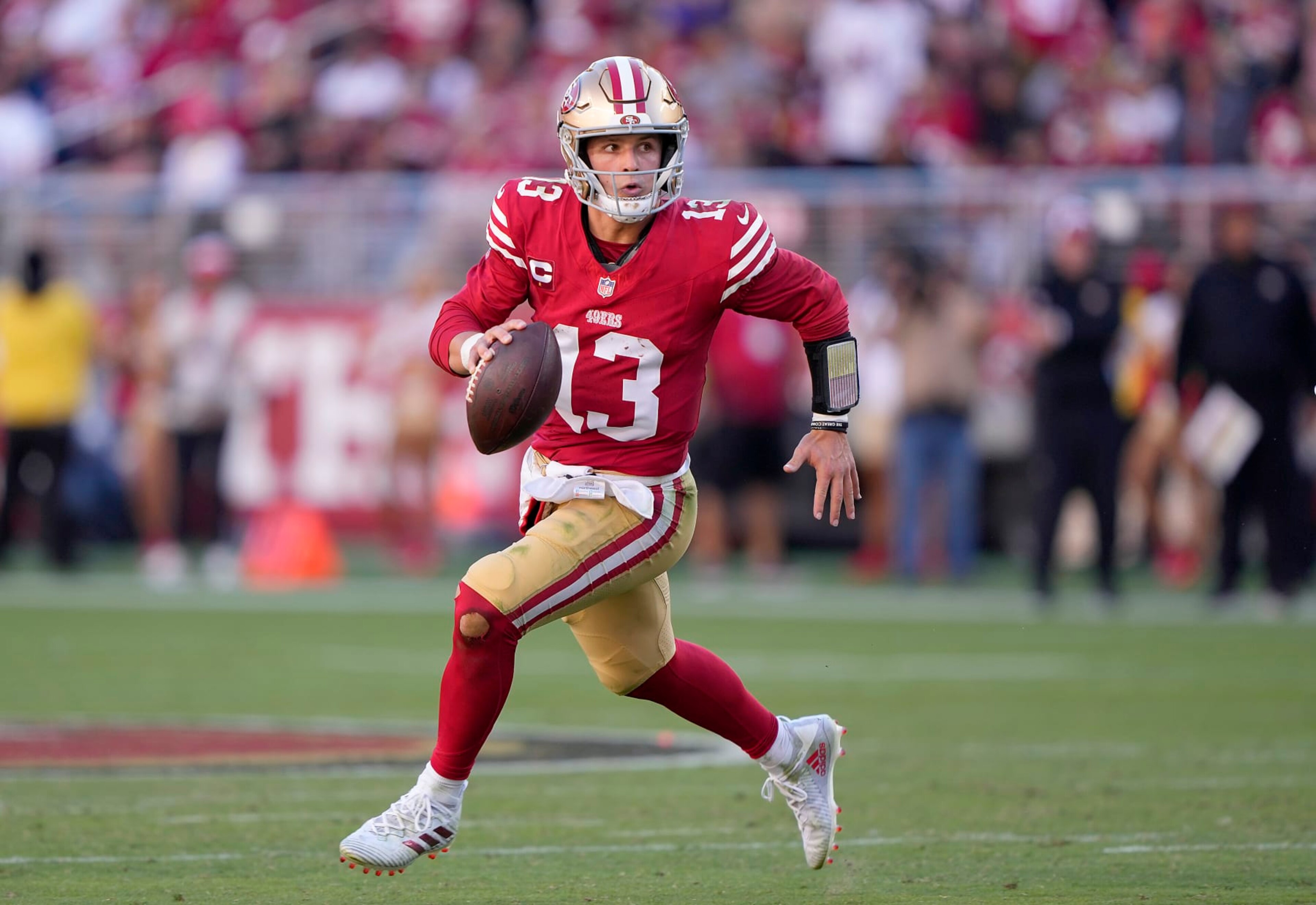 SANTA CLARA, CALIFORNIA - OCTOBER 29: Brock Purdy #13 of the San Francisco 49ers scrambles with the ball looking to pass against the Cincinnati Bengals during the fourth quarter of an NFL football game at Levi's Stadium on October 29, 2023 in Santa Clara, California. (Photo by Thearon W. Henderson/Getty Images)