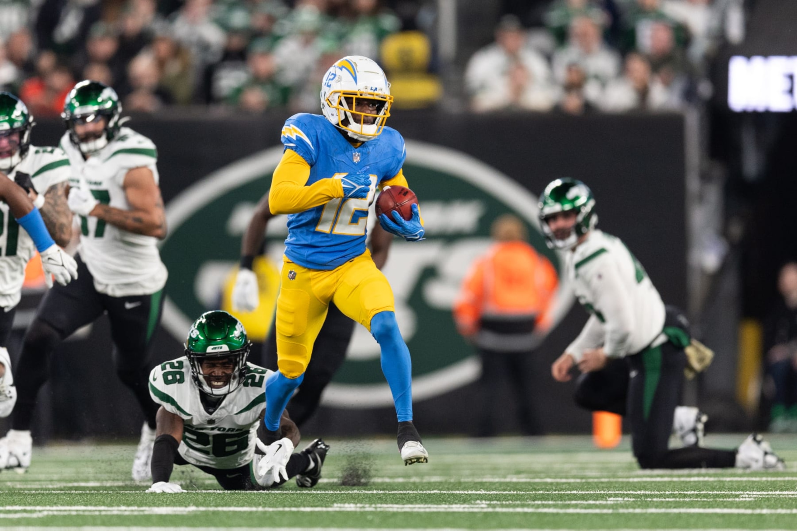 EAST RUTHERFORD, NEW JERSEY - NOVEMBER 06: Derius Davis #12 of the Los Angeles Chargers returns a punt for a touchdown during the first quarter against the New York Jets at MetLife Stadium on November 06, 2023 in East Rutherford, New Jersey. (Photo by Dustin Satloff/Getty Images)