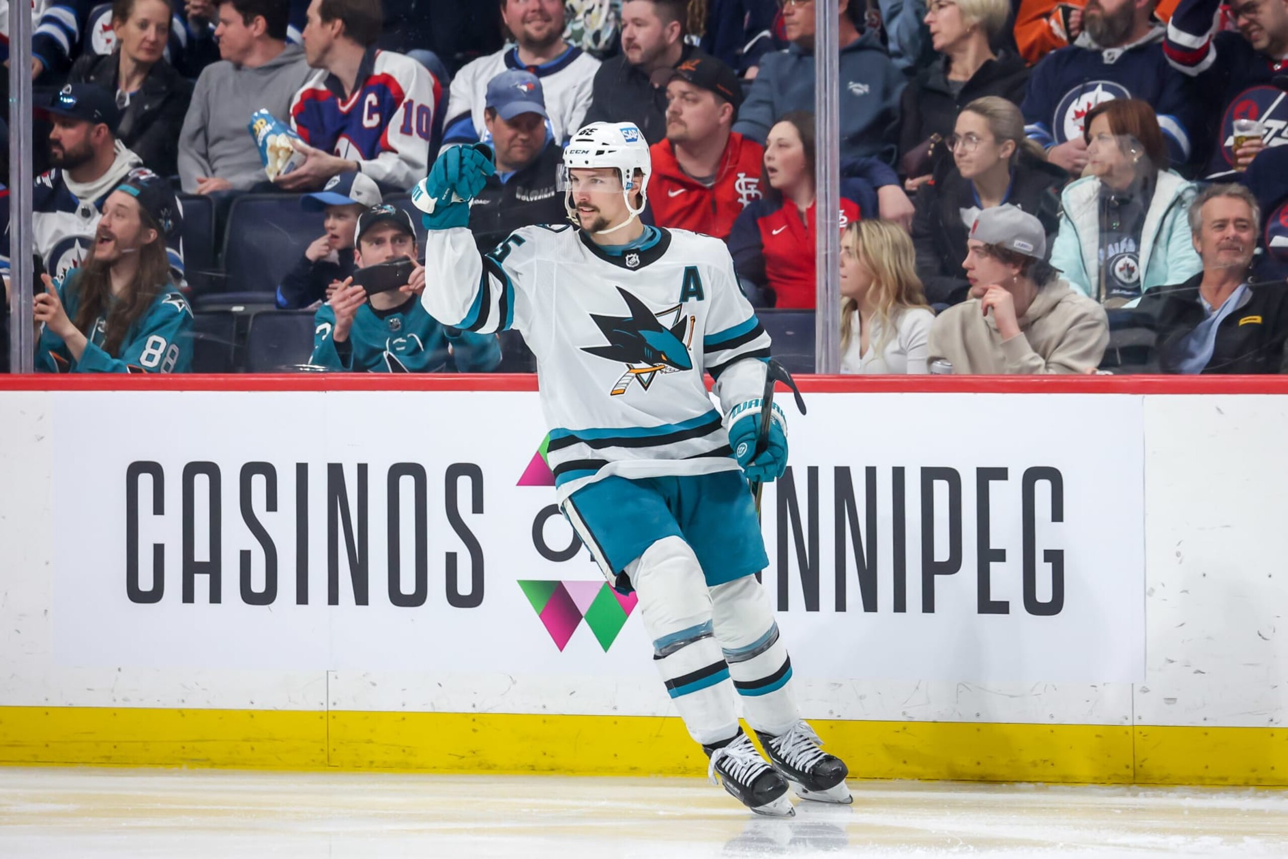 WINNIPEG, CANADA - APRIL 10: Erik Karlsson #65 of the San Jose Sharks celebrates his third period goal against the Winnipeg Jets at the Canada Life Centre on April 10, 2023 in Winnipeg, Manitoba, Canada. The goal is Karlsson's 100th point of the season making him the sixth defenseman in NHL history to reach that milestone. (Photo by Jonathan Kozub/NHLI via Getty Images)