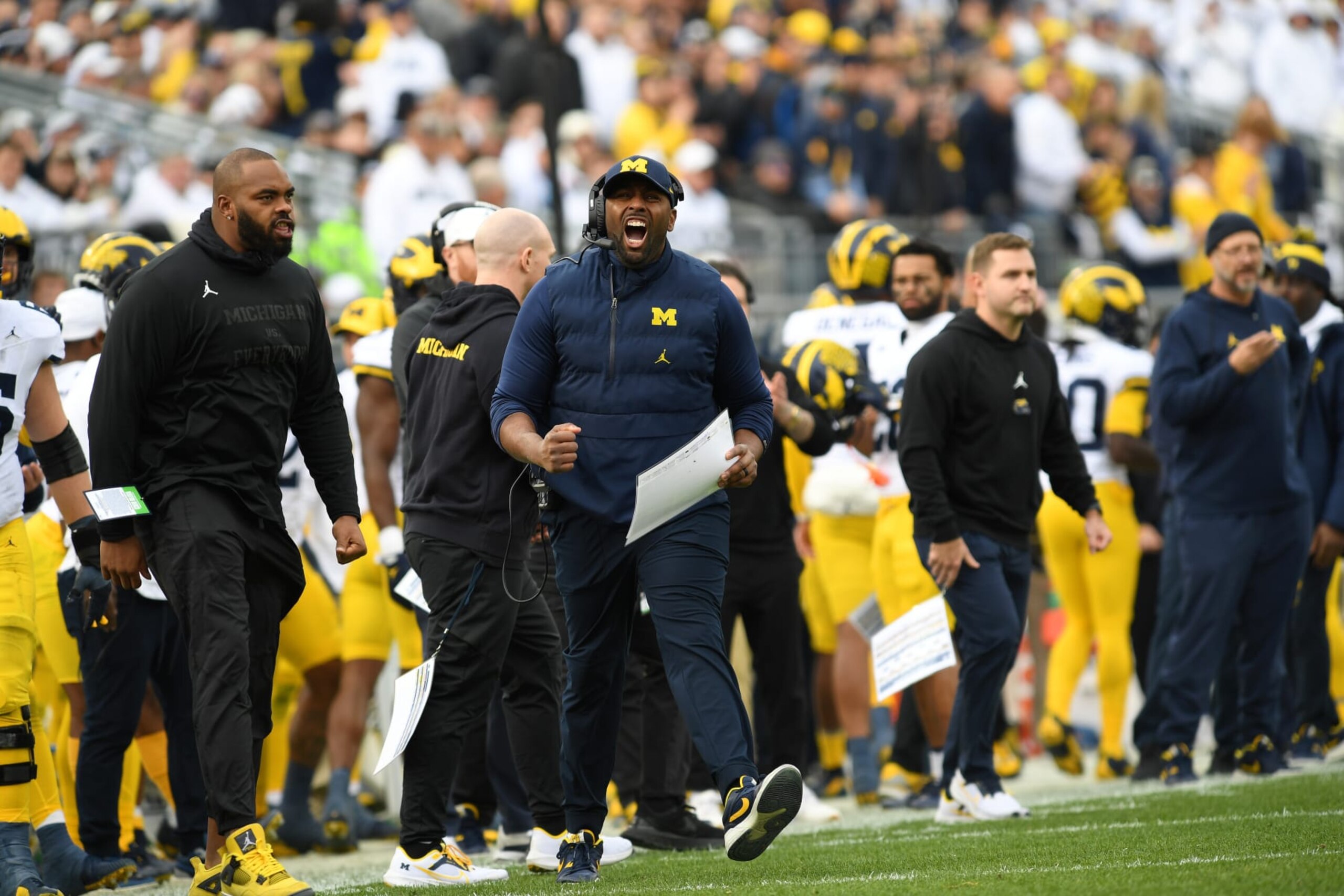 UNIVERSITY PARK, PA - NOVEMBER 11: Michigan acting head coach and offensive coordinator Sherrone Moore celebrates on the slide line during the Michigan Wolverines versus Penn State Nittany Lions game on November 11, 2023 at Beaver Stadium in University Park, PA. (Photo by Randy Litzinger/Icon Sportswire via Getty Images)