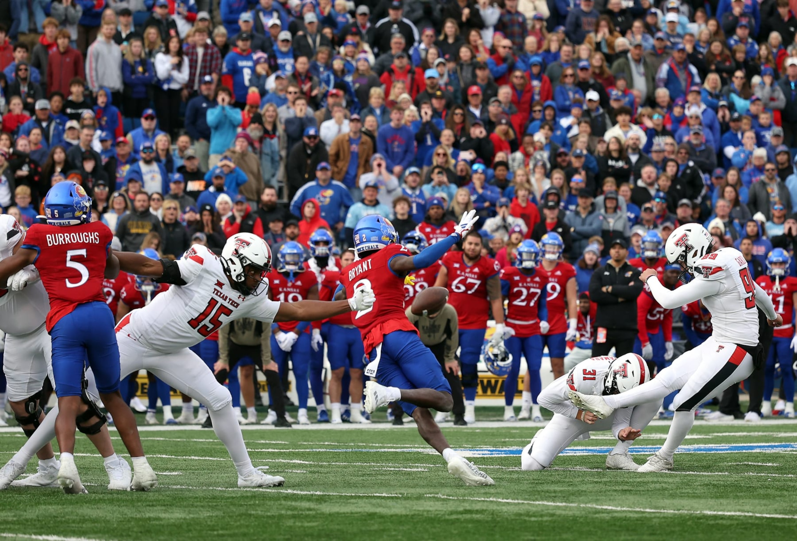 LAWRENCE, KANSAS - NOVEMBER 11:  Place kicker Gino Garcia #99 of the Texas Tech Red Raiders kicks the game-winning field goal during the 2nd half of the game against the Kansas Jayhawks at David Booth Kansas Memorial Stadium on November 11, 2023 in Lawrence, Kansas. (Photo by Jamie Squire/Getty Images)