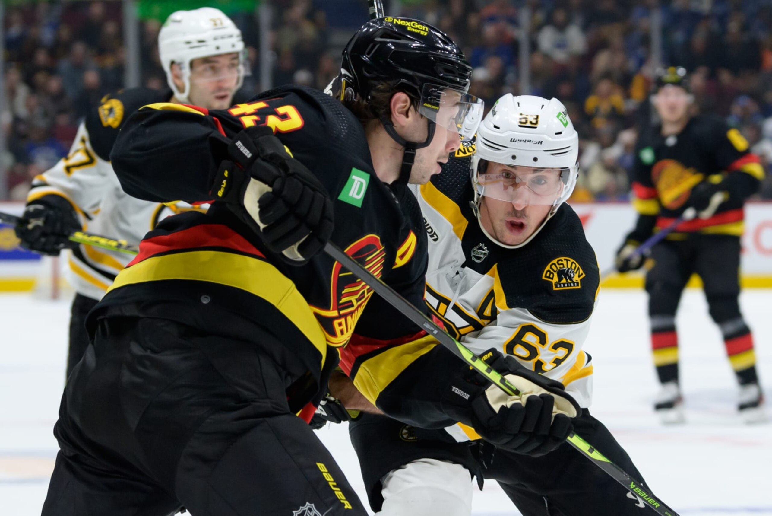 VANCOUVER, CANADA - FEBRUARY 25: Quinn Hughes #43 of the Vancouver Canucks defends against Brad Marchand #63 of the Boston Bruins during the third period of their NHL game at Rogers Arena on February 25, 2023 in Vancouver, British Columbia, Canada. (Photo by Derek Cain/Getty Images)