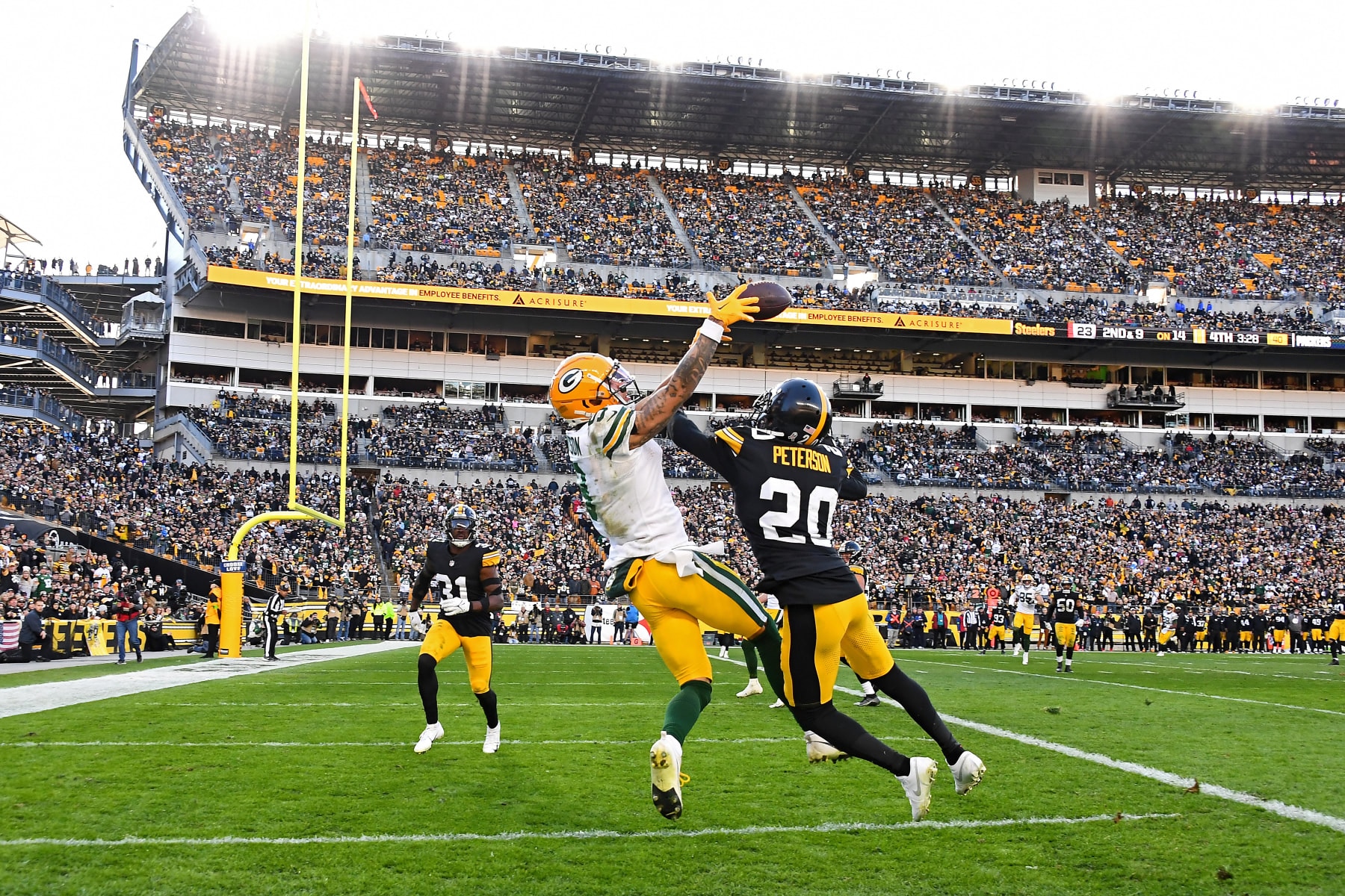 Packers WR Christian Watson is defended by Steelers CB Patrick Peterson