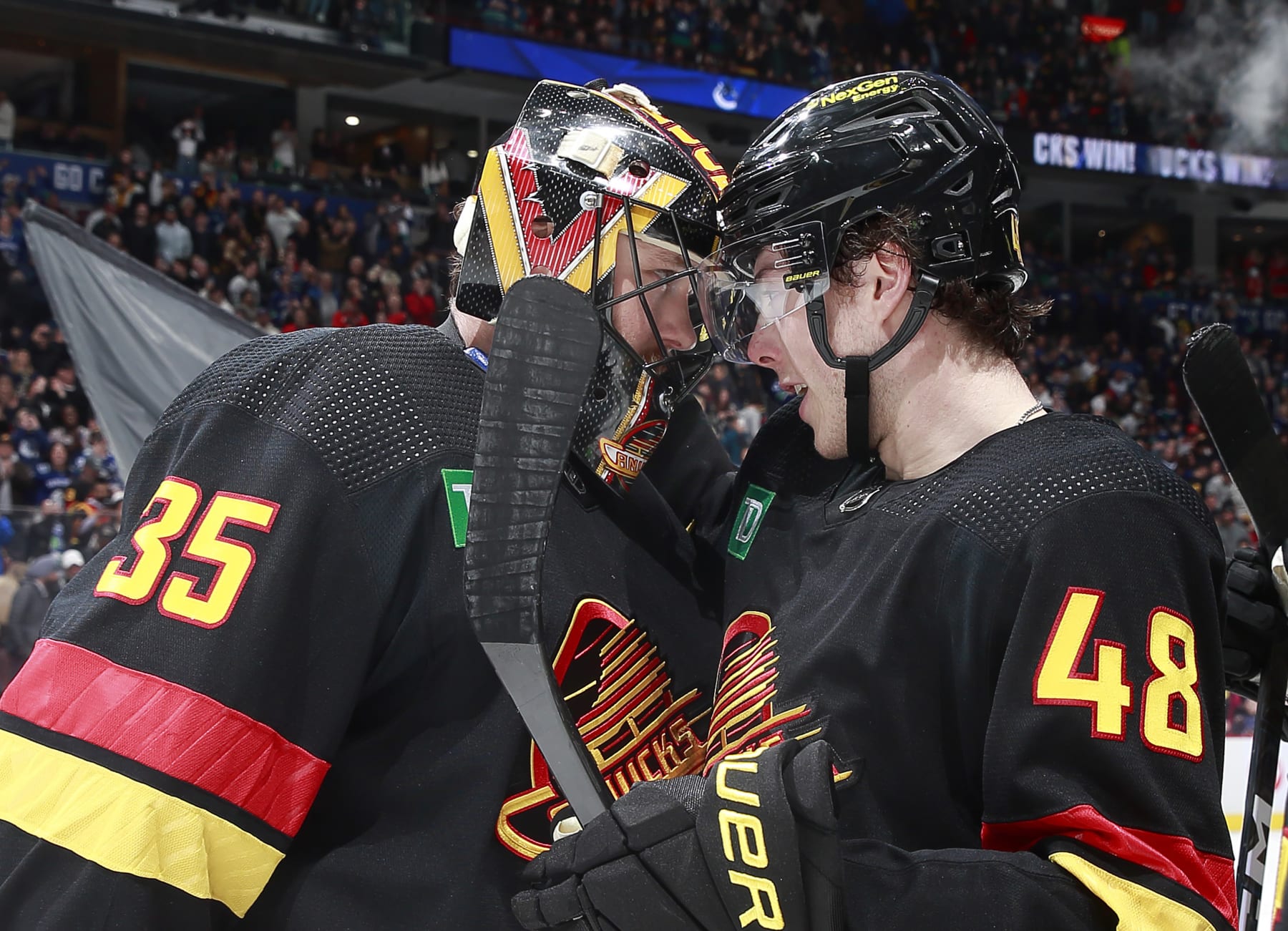 VANCOUVER, CANADA - APRIL 8: Thatcher Demko #35 and Cole McWard #48 of the Vancouver Canucks celebrate their win over the Calgary Flames during their NHL game at Rogers Arena April 8, 2023 in Vancouver, British Columbia, Canada.  (Photo by Jeff Vinnick/NHLI via Getty Images)