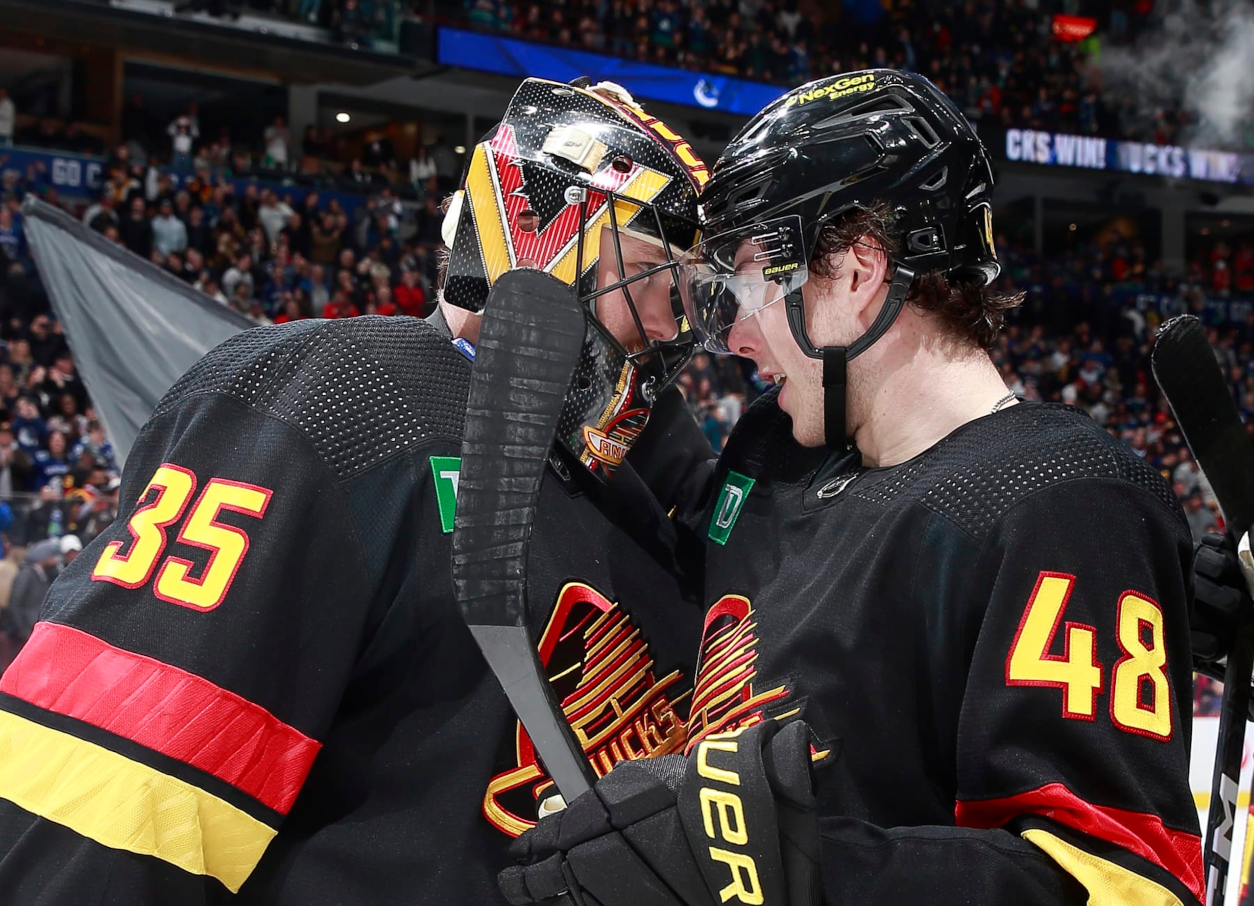 VANCOUVER, CANADA - APRIL 8: Thatcher Demko #35 and Cole McWard #48 of the Vancouver Canucks celebrate their win over the Calgary Flames during their NHL game at Rogers Arena April 8, 2023 in Vancouver, British Columbia, Canada.  (Photo by Jeff Vinnick/NHLI via Getty Images)