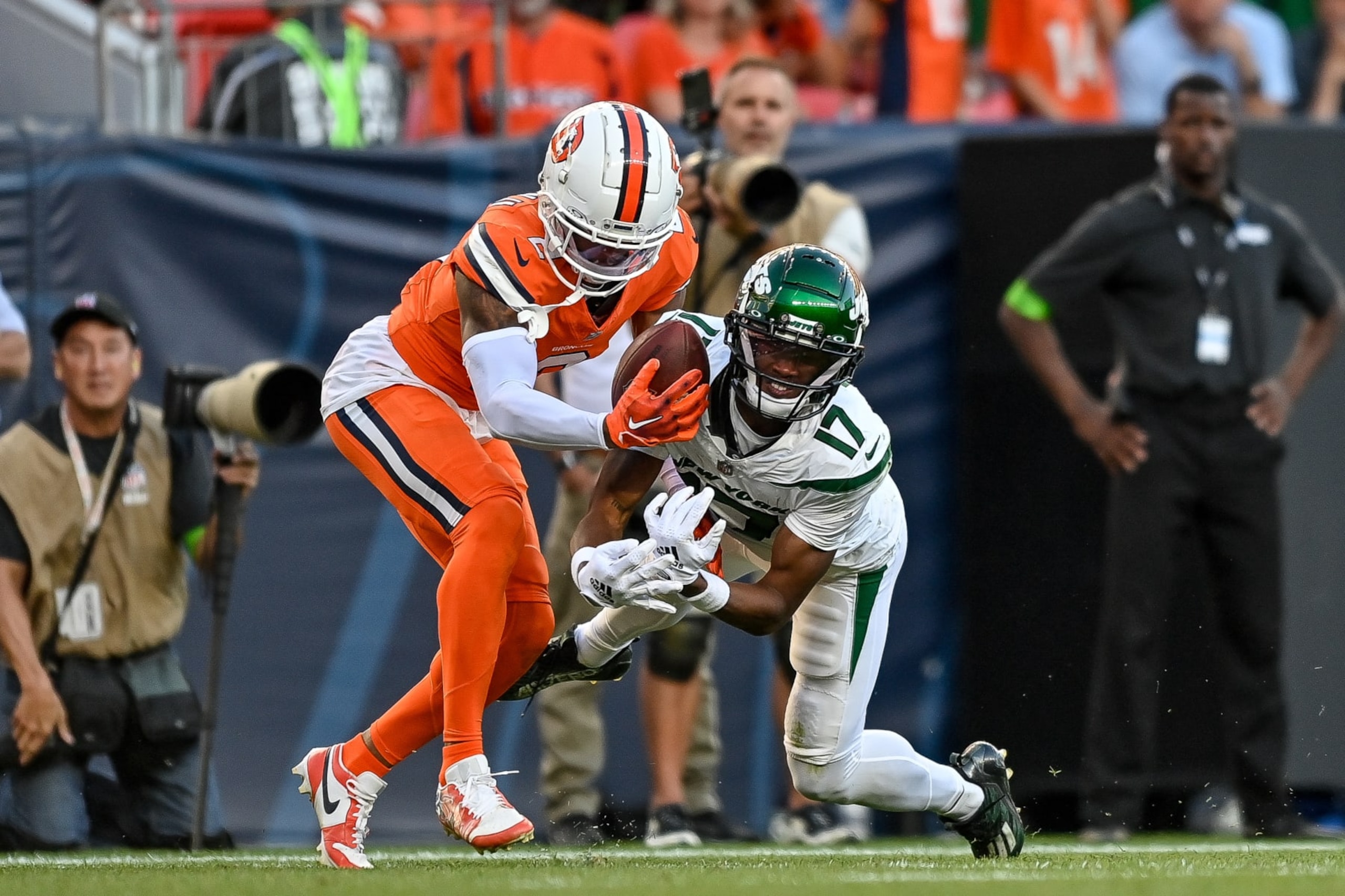 DENVER, CO - OCTOBER 8: Denver Broncos cornerback Pat Surtain II (2) intercepts a pass intended for New York Jets wide receiver Garrett Wilson (17) in the fourth quarter during a game between the New York Jets and the Denver Broncos at Empower Field at Mile High on October 8, 2023 in Denver, Colorado. (Photo by Dustin Bradford/Icon Sportswire via Getty Images)