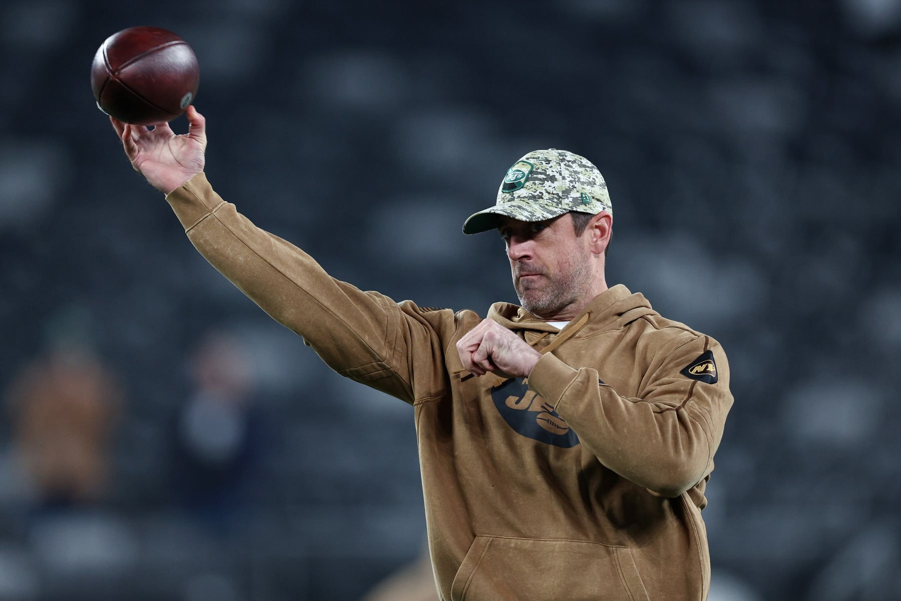 EAST RUTHERFORD, NEW JERSEY - NOVEMBER 06:  Aaron Rodgers #8 of the New York Jets throws a football before the game against the Los Angeles Chargers at MetLife Stadium on November 06, 2023 in East Rutherford, New Jersey. (Photo by Elsa/Getty Images)