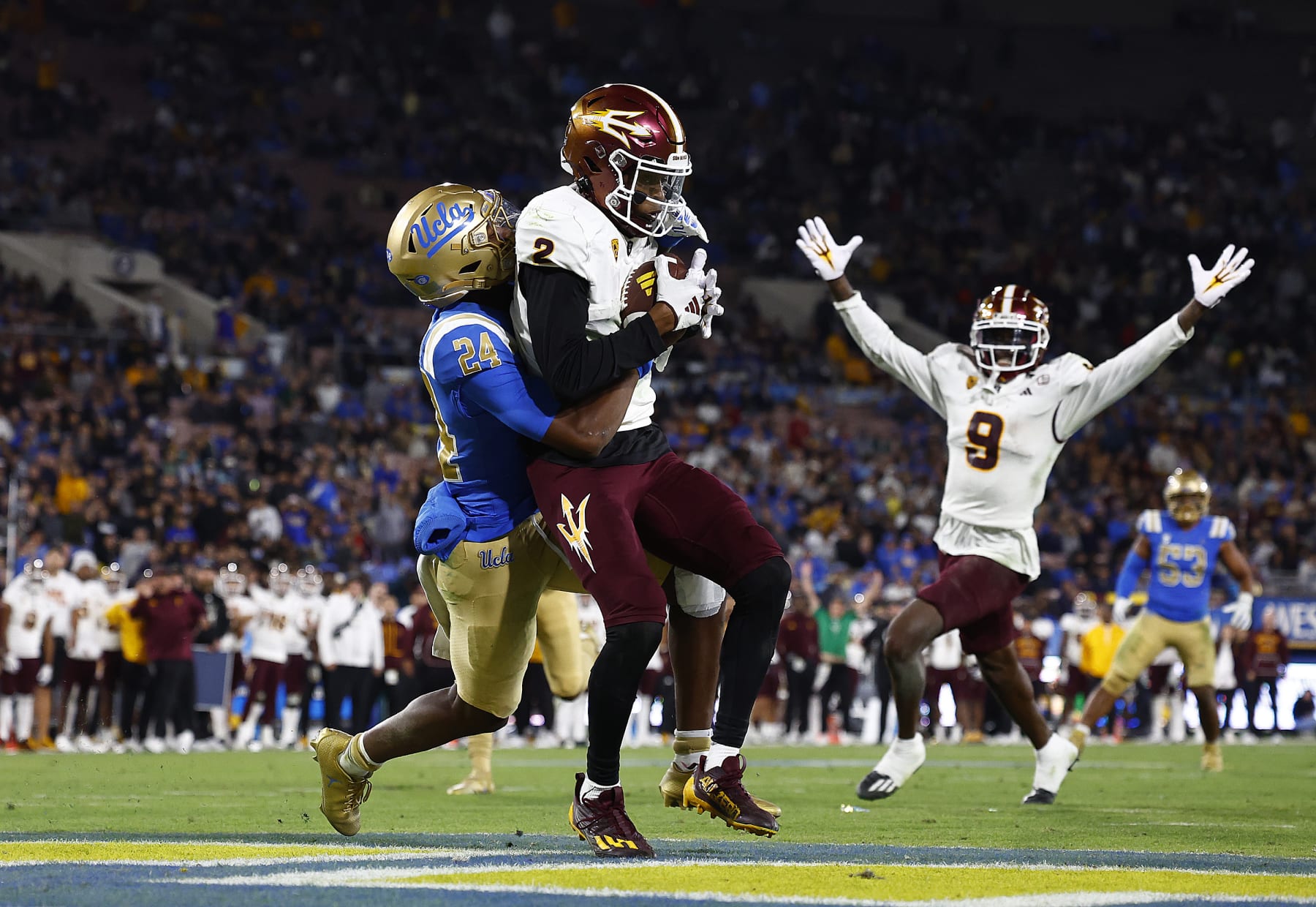 PASADENA, CALIFORNIA - NOVEMBER 11:  Elijhah Badger #2 of the Arizona State Sun Devils makes a touchdown pass reception against Jaylin Davies #24 of the UCLA Bruins in the second half at Rose Bowl Stadium on November 11, 2023 in Pasadena, California. (Photo by Ronald Martinez/Getty Images)