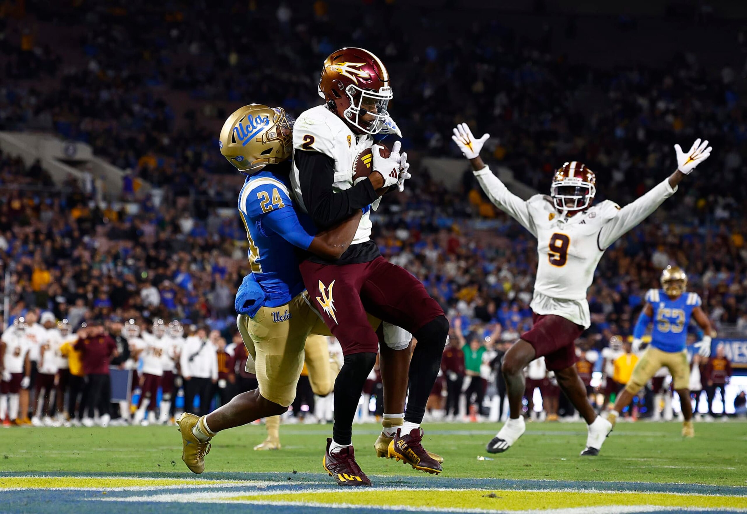 PASADENA, CALIFORNIA - NOVEMBER 11:  Elijhah Badger #2 of the Arizona State Sun Devils makes a touchdown pass reception against Jaylin Davies #24 of the UCLA Bruins in the second half at Rose Bowl Stadium on November 11, 2023 in Pasadena, California. (Photo by Ronald Martinez/Getty Images)