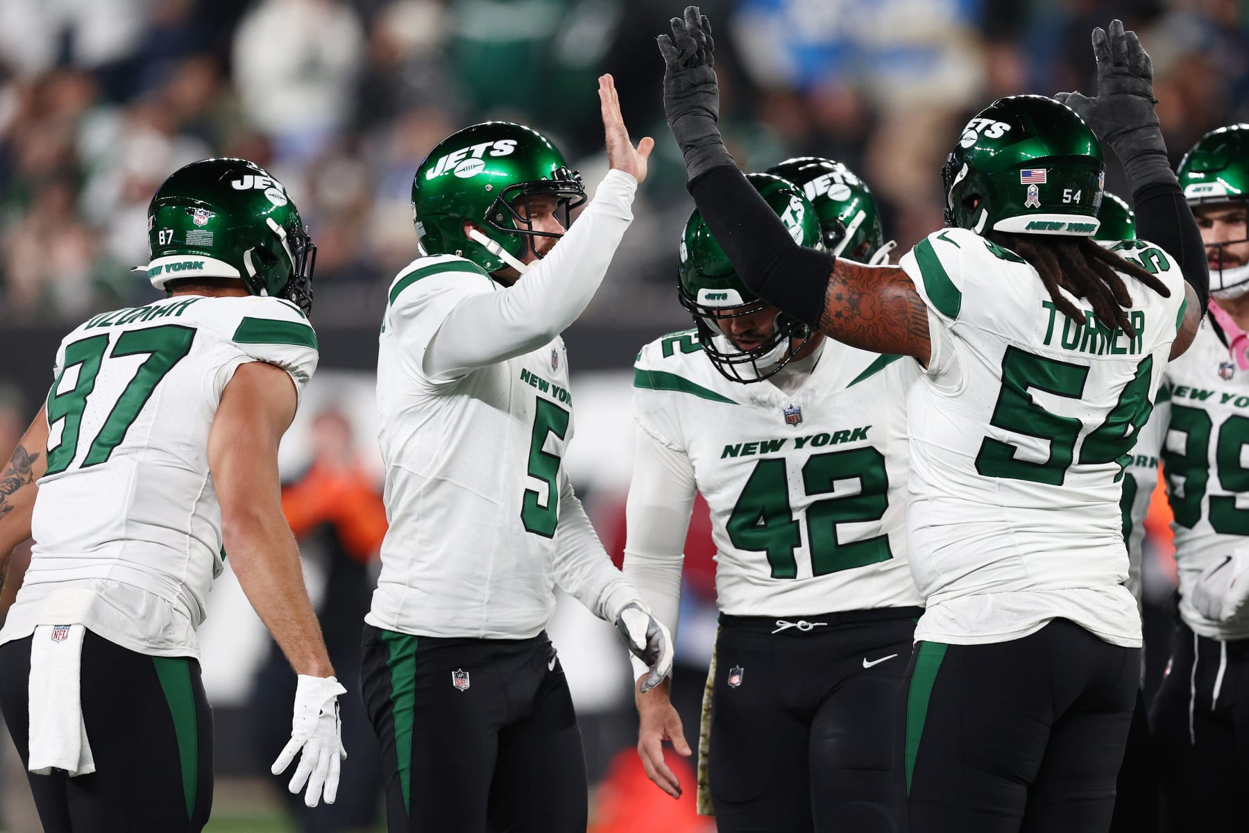 EAST RUTHERFORD, NEW JERSEY - NOVEMBER 06: Greg Zuerlein #9 of the New York Jets celebrates with teammates after kicking a 47-yard field goal during the second quarter against the Los Angeles Chargers at MetLife Stadium on November 06, 2023 in East Rutherford, New Jersey. (Photo by Elsa/Getty Images)