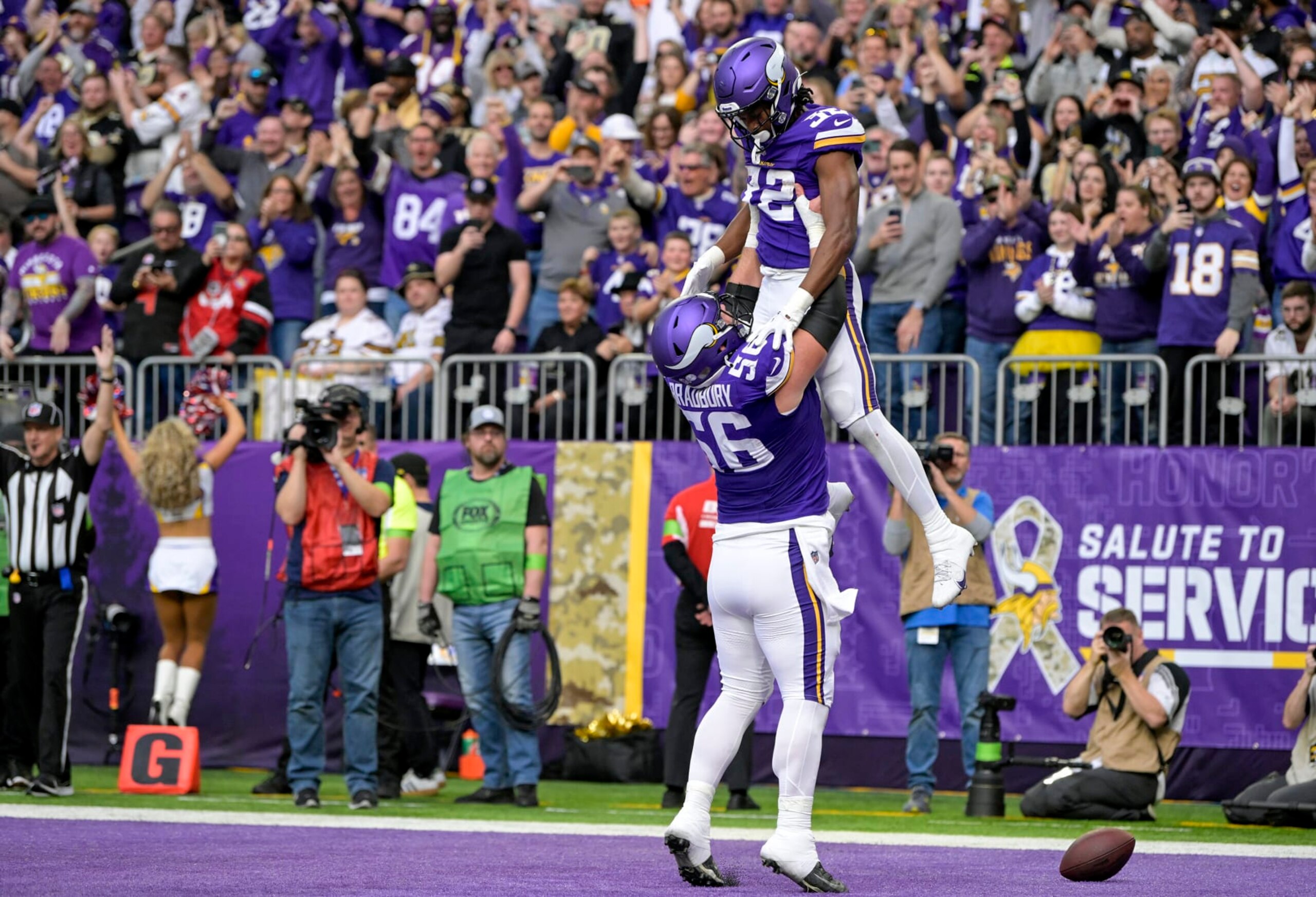 MINNEAPOLIS, MN - NOVEMBER 12: Minnesota Vikings running back Ty Chandler (32) celebrates his 2-yard touchdown run with Minnesota Vikings offensive lineman Garrett Bradbury (56) during the second quarter of an NFL game between the Minnesota Vikings and New Orleans Saints on November 12, 2023, at U.S. Bank Stadium in Minneapolis, MN. (Photo by Nick Wosika/Icon Sportswire via Getty Images)