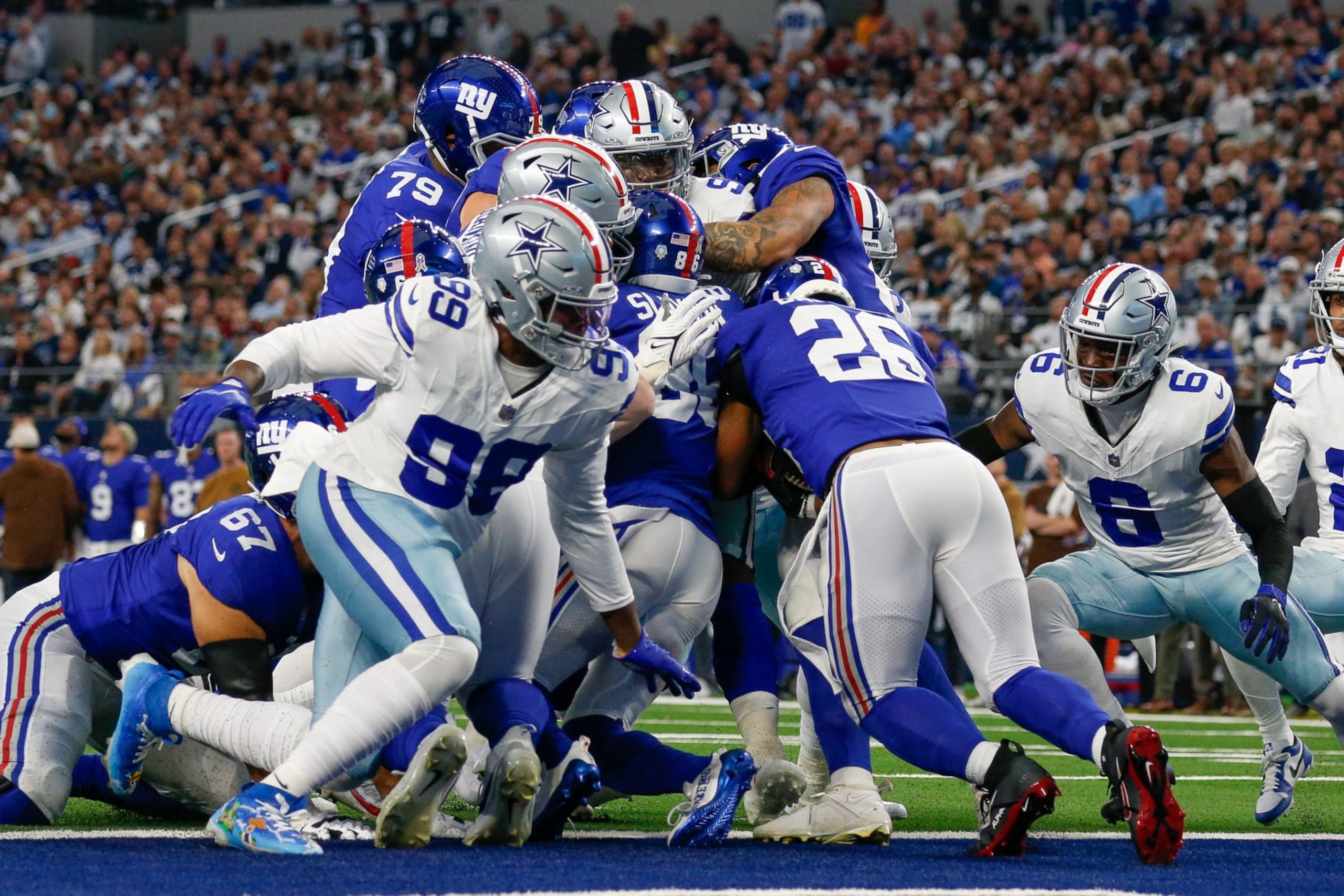 ARLINGTON, TX - NOVEMBER 12: New York Giants running back Saquon Barkley (26) runs into a pile of Dallas Cowboys defenders on the goal line during the game between the Dallas Cowboys and New York Giants on November 12, 2023 at AT&T Stadium in Arlington, TX. (Photo by Andrew Dieb/Icon Sportswire via Getty Images)