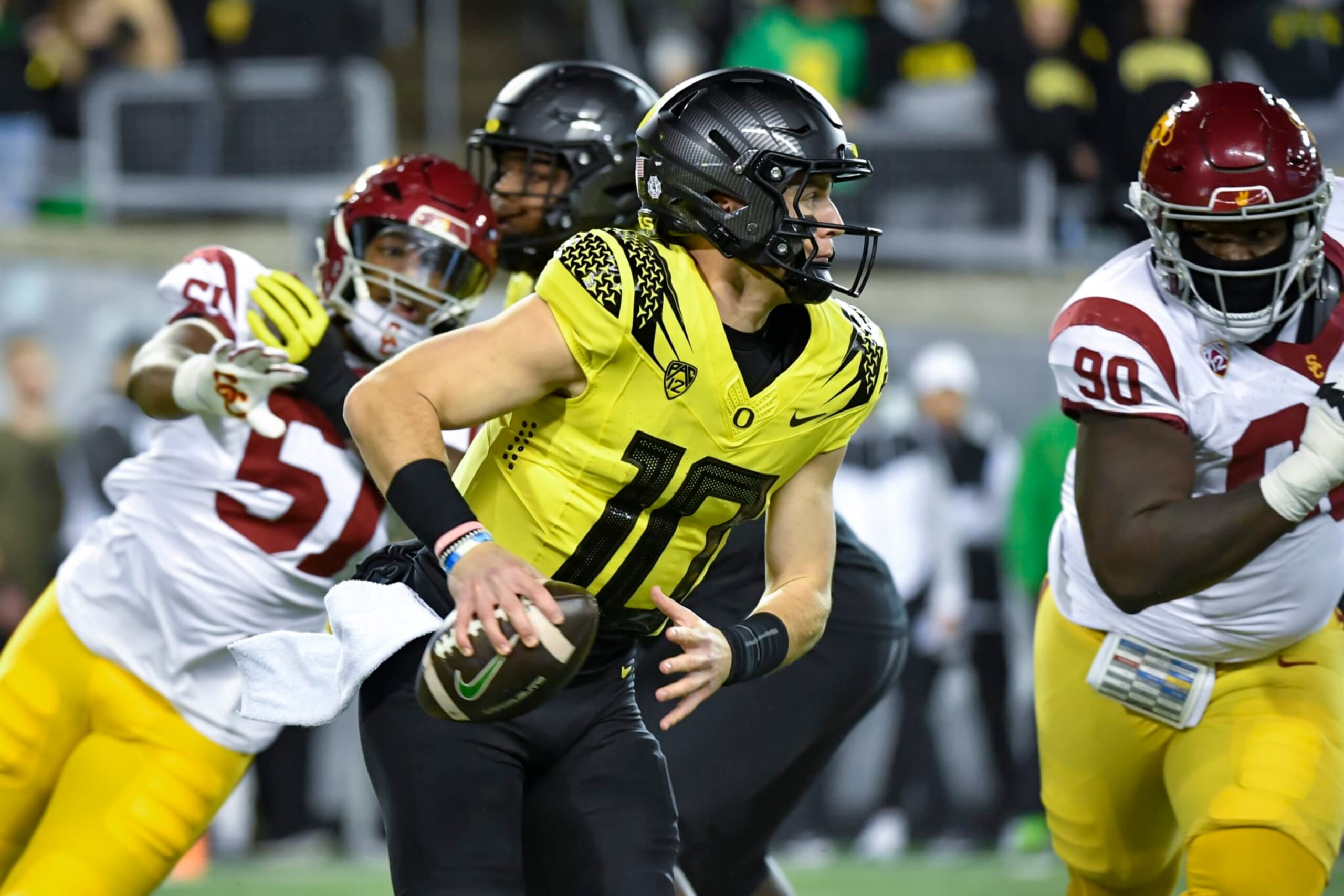 Oregon quarterback Bo Nix (10) scrambles against Southern California during the first half of an NCAA college football game Saturday, Nov. 11, 2023, in Eugene, Ore. (AP Photo/Andy Nelson) Oregon quarterback Bo Nix (10) scrambles against Southern California during the first half of an NCAA college football game Saturday, Nov. 11, 2023, in Eugene, Ore. (AP Photo/Andy Nelson)