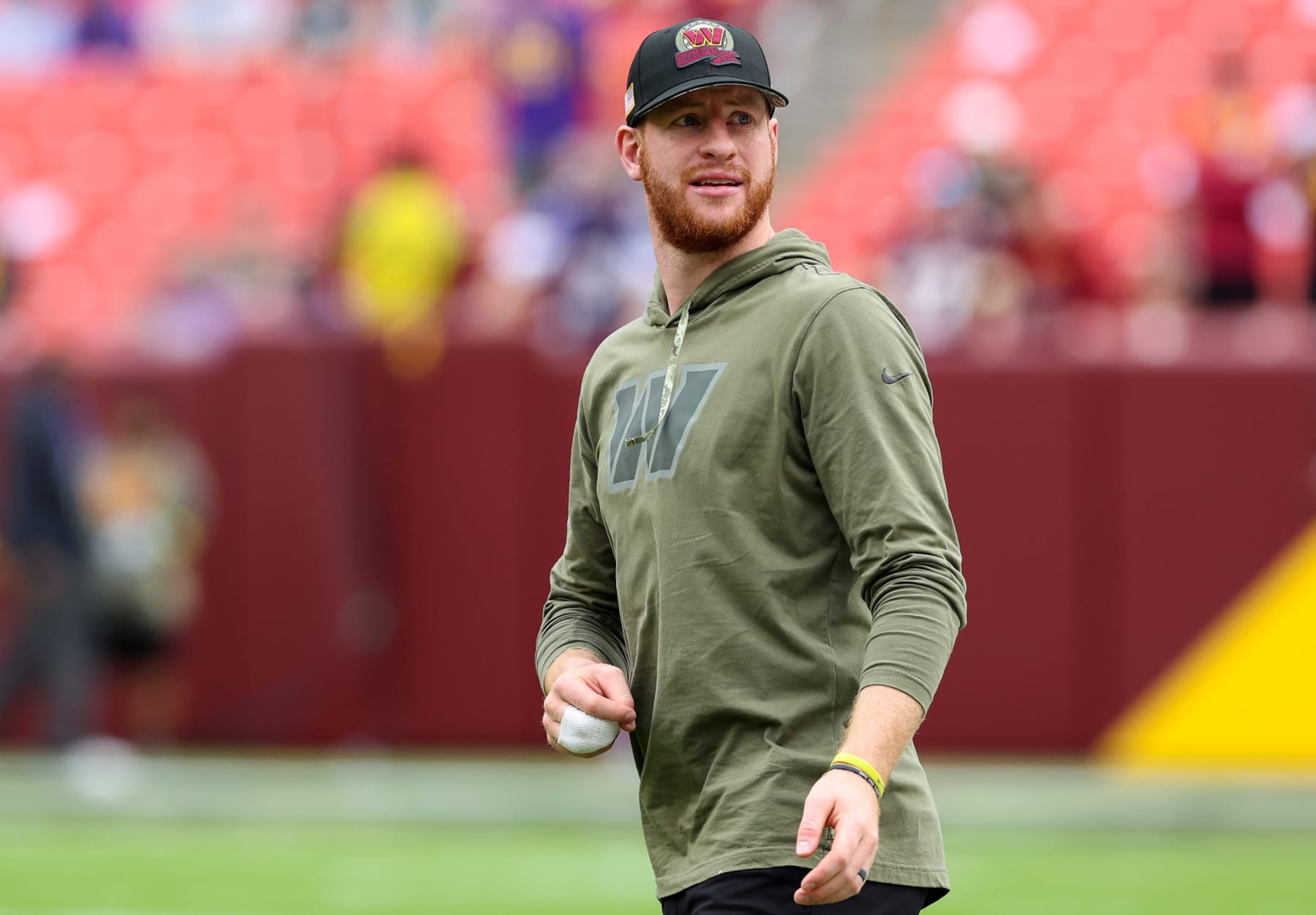 LANDOVER, MARYLAND - NOVEMBER 06: Carson Wentz #11 of the Washington Commanders stands on the field during pregame prior to the game against the Minnesota Vikings at FedExField on November 06, 2022 in Landover, Maryland. (Photo by Todd Olszewski/Getty Images)