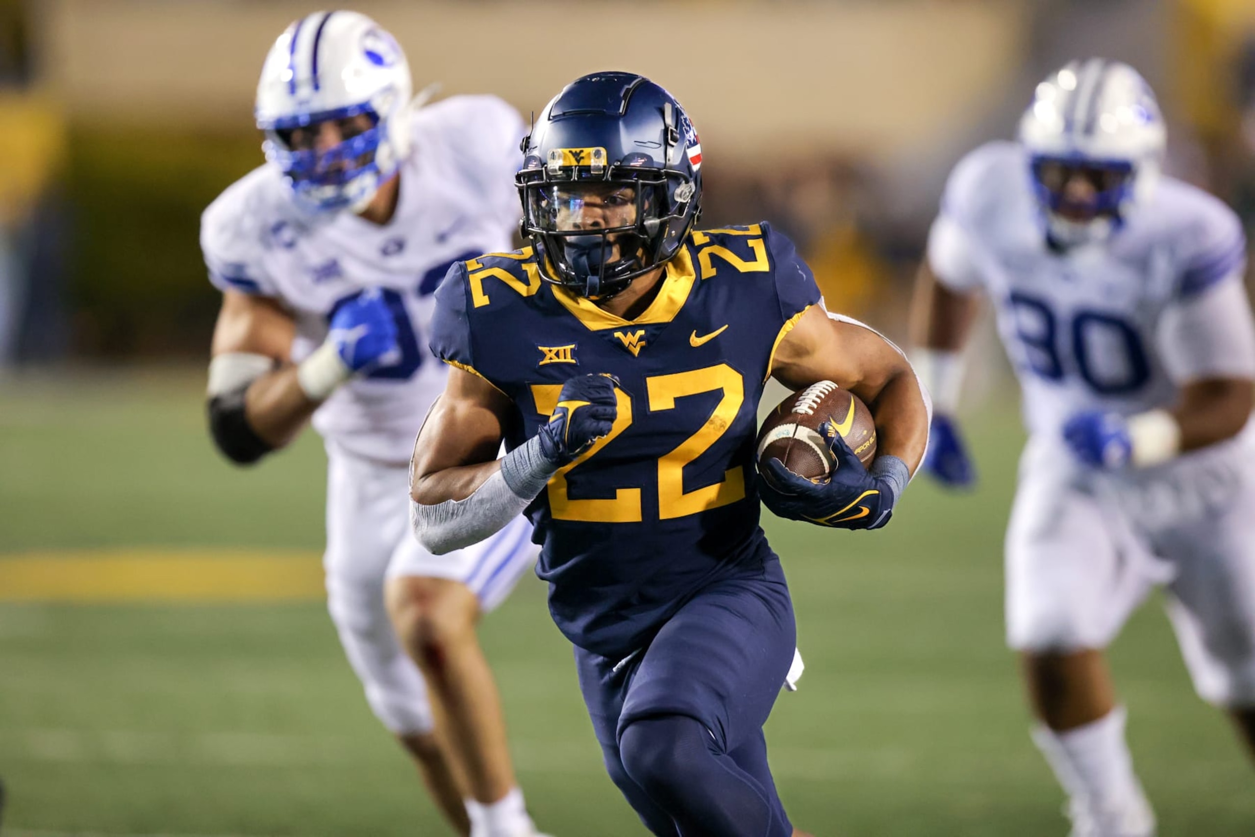 MORGANTOWN, WV - NOVEMBER 04: West Virginia Mountaineers running back Jahiem White (22) carries the football during the third quarter of the college football game between the BYU Cougars and the West Virginia Mountaineers on November 4, 2023, at Mountaineer Field at Milan Puskar Stadium in Morgantown, WV. (Photo by Frank Jansky/Icon Sportswire via Getty Images) MORGANTOWN, WV - NOVEMBER 04: West Virginia Mountaineers running back Jahiem White (22) carries the football during the third quarter of the college football game between the BYU Cougars and the West Virginia Mountaineers on November 4, 2023, at Mountaineer Field at Milan Puskar Stadium in Morgantown, WV. (Photo by Frank Jansky/Icon Sportswire via Getty Images)