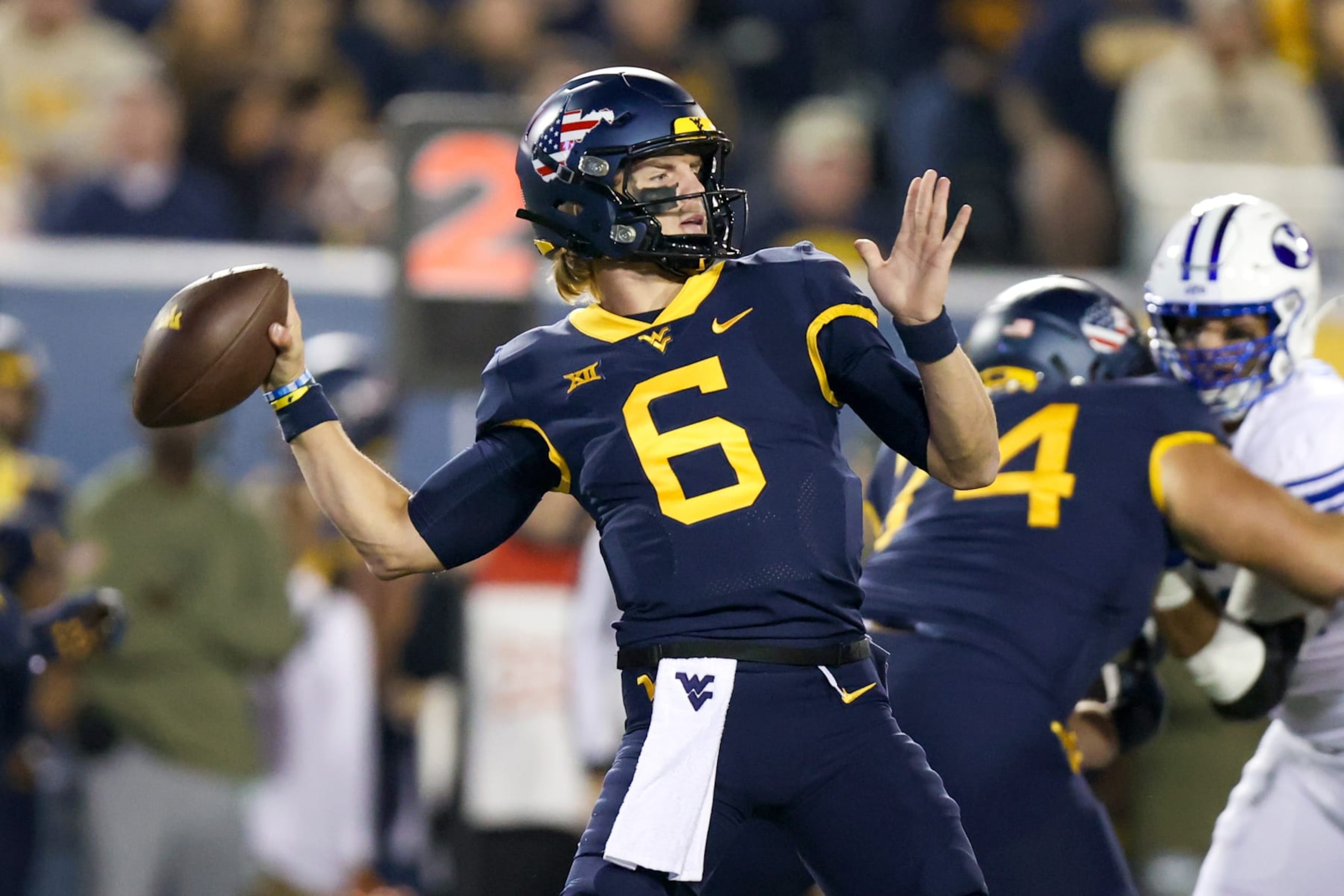 MORGANTOWN, WV - NOVEMBER 04: West Virginia Mountaineers quarterback Garrett Greene (6) throws a pass during the first quarter of the college football game between the BYU Cougars and the West Virginia Mountaineers on November 4, 2023, at Mountaineer Field at Milan Puskar Stadium in Morgantown, WV. (Photo by Frank Jansky/Icon Sportswire via Getty Images) MORGANTOWN, WV - NOVEMBER 04: West Virginia Mountaineers quarterback Garrett Greene (6) throws a pass during the first quarter of the college football game between the BYU Cougars and the West Virginia Mountaineers on November 4, 2023, at Mountaineer Field at Milan Puskar Stadium in Morgantown, WV. (Photo by Frank Jansky/Icon Sportswire via Getty Images)