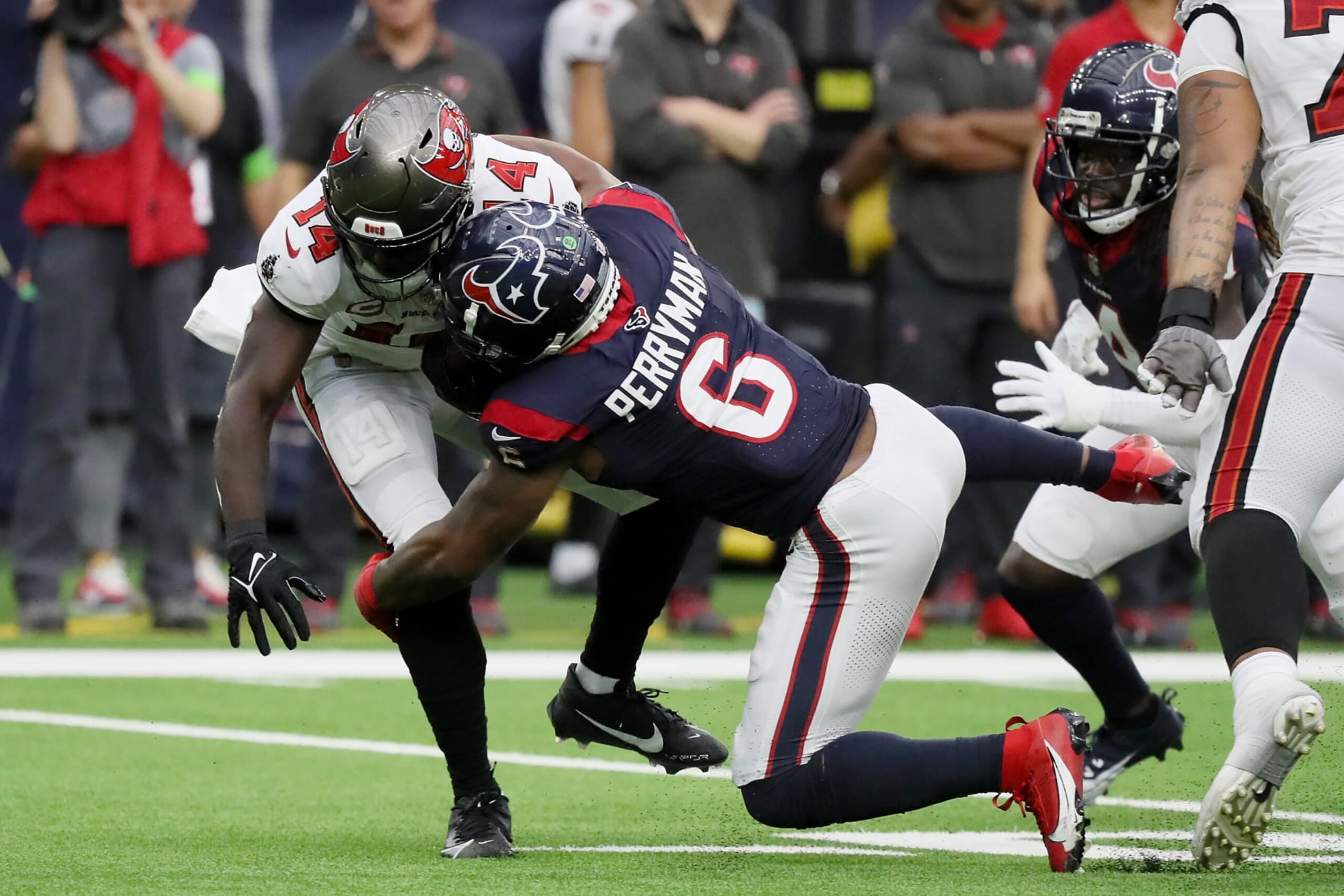HOUSTON, TEXAS - NOVEMBER 05: Chris Godwin #14 of the Tampa Bay Buccaneers is tackled by Denzel Perryman #6 of the Houston Texans in the third quarter of a game at NRG Stadium on November 05, 2023 in Houston, Texas. (Photo by Bob Levey/Getty Images) HOUSTON, TEXAS - NOVEMBER 05: Chris Godwin #14 of the Tampa Bay Buccaneers is tackled by Denzel Perryman #6 of the Houston Texans in the third quarter of a game at NRG Stadium on November 05, 2023 in Houston, Texas. (Photo by Bob Levey/Getty Images)