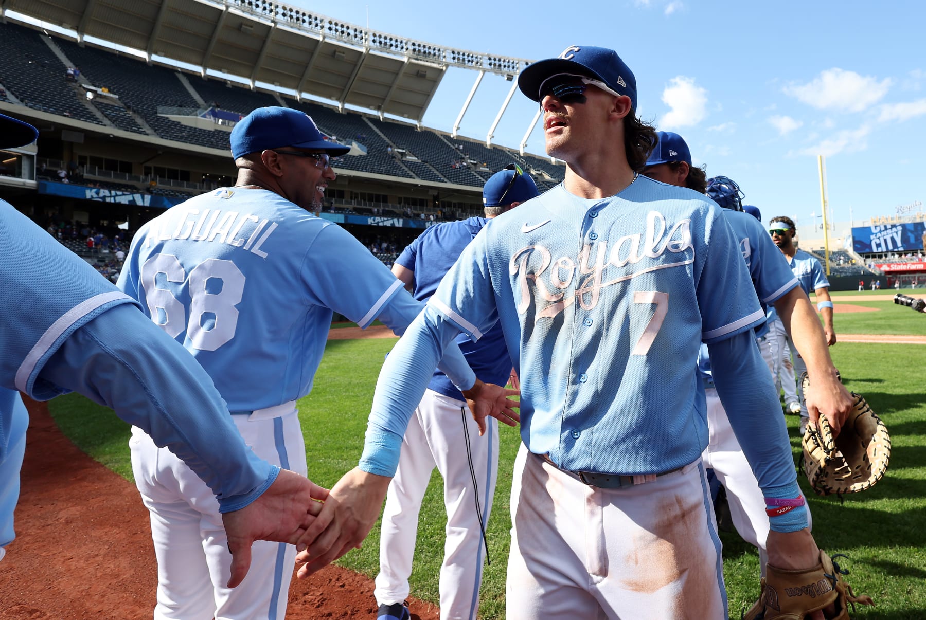 KANSAS CITY, MISSOURI - SEPTEMBER 20:  Bobby Witt Jr. #7 of the Kansas City Royals congratulates teammates after the Royals defeated the Cleveland Guardians 6-2 to win the game at Kauffman Stadium on September 20, 2023 in Kansas City, Missouri. (Photo by Jamie Squire/Getty Images)