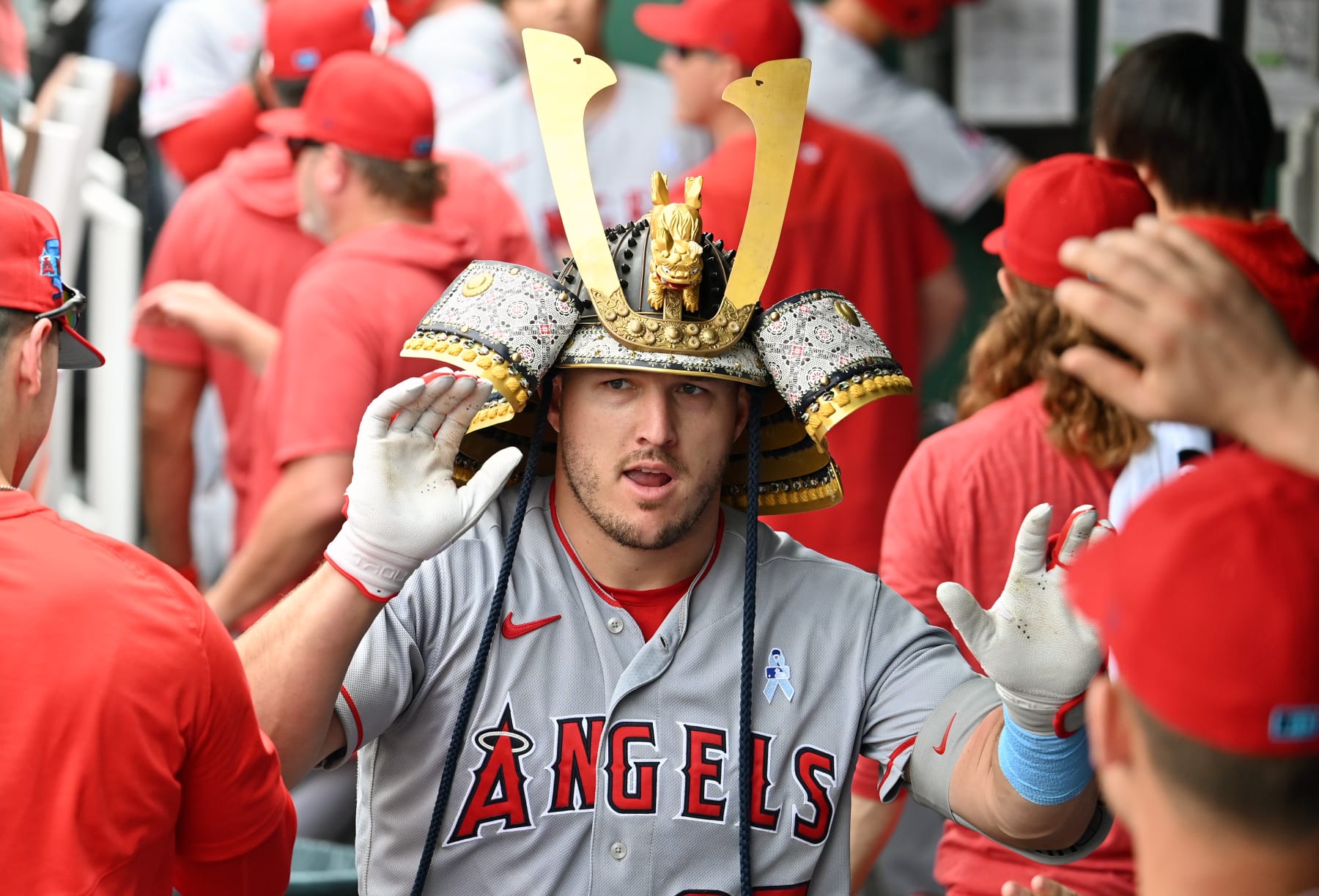 KANSAS CITY, MO - JUNE 18: Los Angeles Angels center fielder Mike Trout (27) wears the team's Samurai hat in the dugout after hitting a solo home run during a MLB game between the California Angels and the Kansas City Royals on June 18, 2023, at Kauffman Stadium in Kansas City, Mo. (Photo by Keith Gillett/Icon Sportswire via Getty Images)