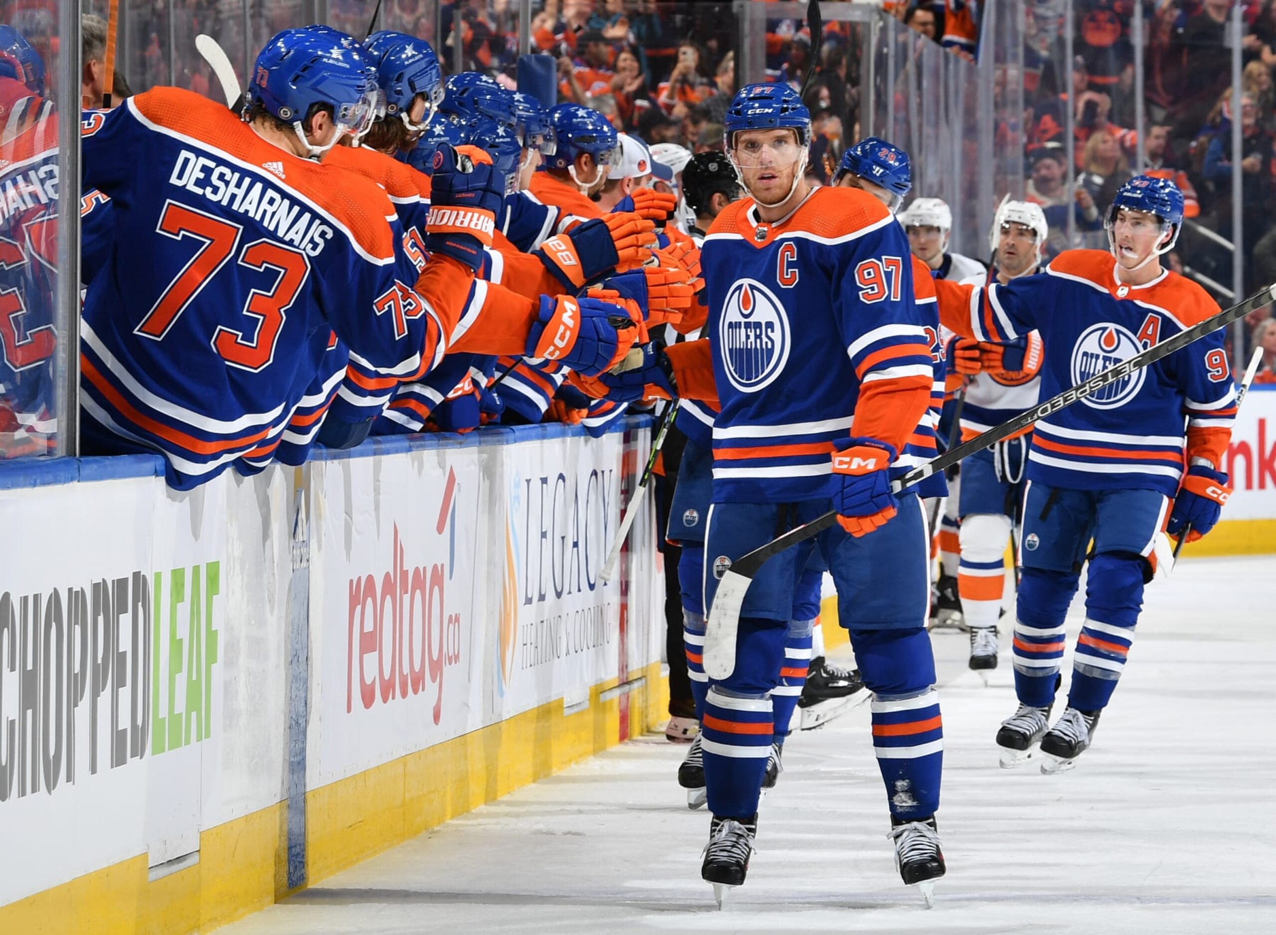 EDMONTON, CANADA - NOVEMBER 13: Connor McDavid #97 of the Edmonton Oilers celebrates with his teammates at the bench after his third period goal against the New York Islanders during the game at Rogers Place on November 13, 2023, in Edmonton, Alberta, Canada. (Photo by Andy Devlin/NHLI via Getty Images)