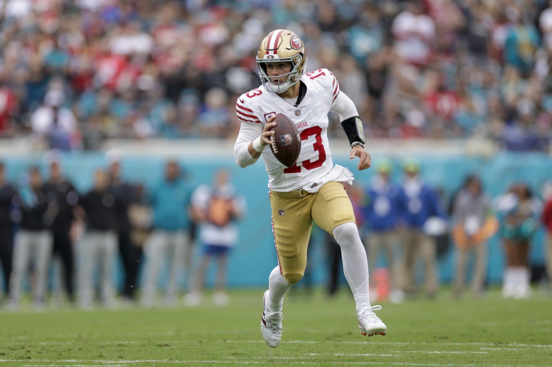 JACKSONVILLE, FL - NOVEMBER 12:  San Francisco 49ers quarterback Brock Purdy (13) runs with the ball during the game between the San Francisco 49ers and theJacksonville Jaguars on November 12, 2023 at  EverBank Stadium in Jacksonville, Florida. (Photo by David Rosenblum/Icon Sportswire via Getty Images)
