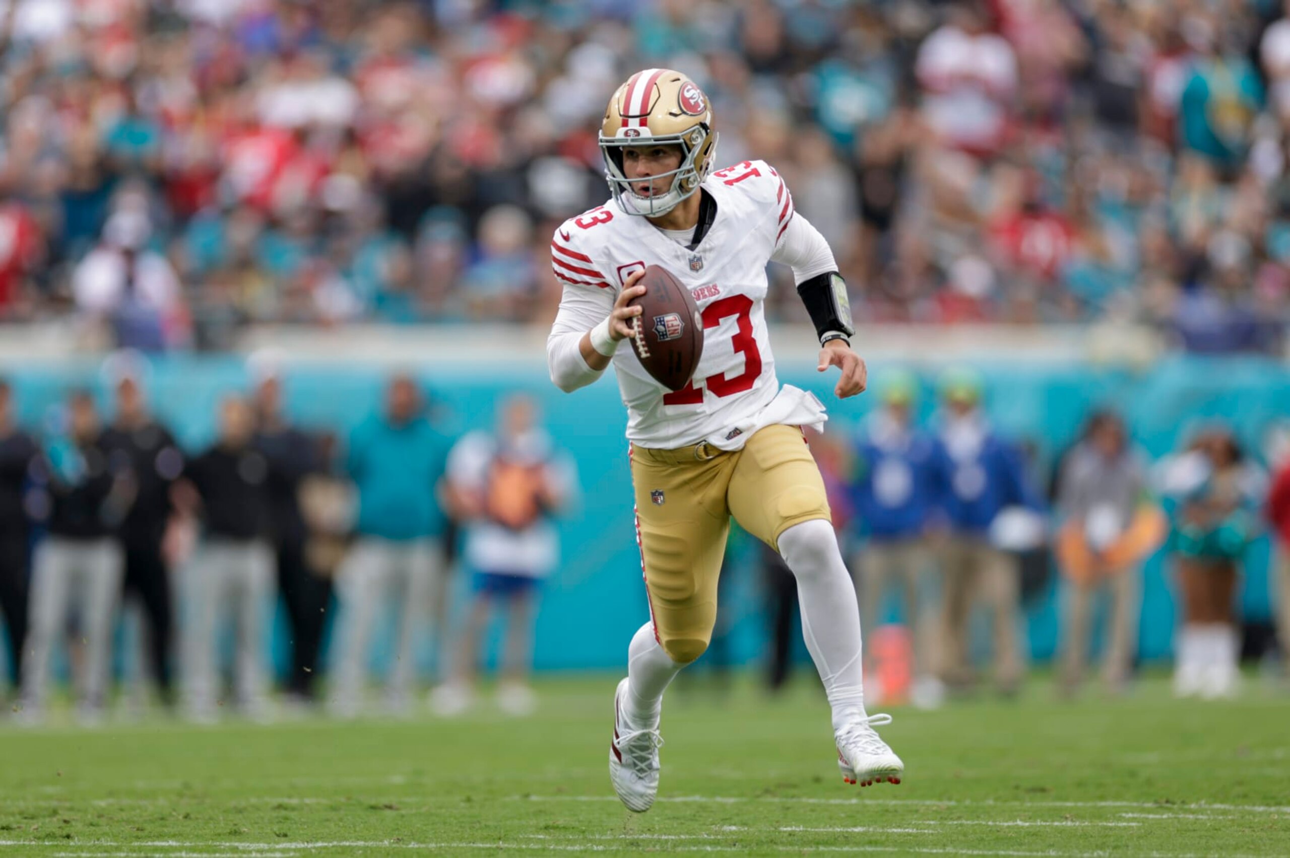 JACKSONVILLE, FL - NOVEMBER 12:  San Francisco 49ers quarterback Brock Purdy (13) runs with the ball during the game between the San Francisco 49ers and theJacksonville Jaguars on November 12, 2023 at  EverBank Stadium in Jacksonville, Florida. (Photo by David Rosenblum/Icon Sportswire via Getty Images)