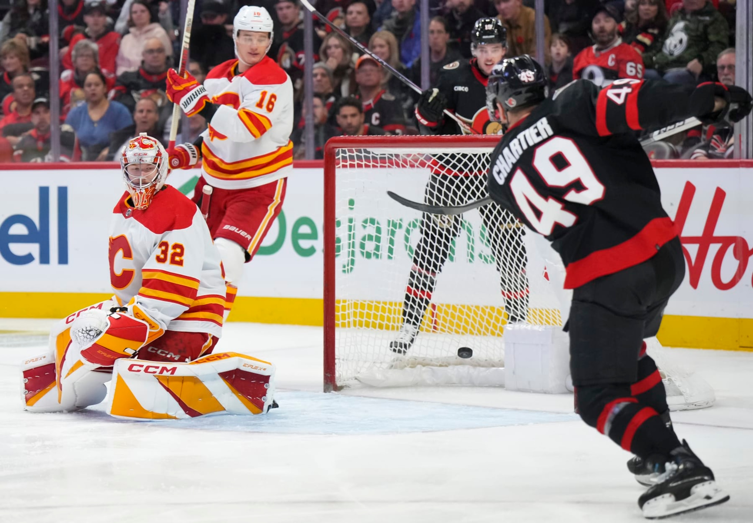 OTTAWA, CANADA - NOVEMBER 11: Rourke Chartier #49 of the Ottawa Senators scores a third period goal against Dustin Wolf #32 of the Calgary Flames at Canadian Tire Centre on November 11, 2023 in Ottawa, Ontario, Canada. (Photo by André Ringuette/NHLI via Getty Images) OTTAWA, CANADA - NOVEMBER 11: Rourke Chartier #49 of the Ottawa Senators scores a third period goal against Dustin Wolf #32 of the Calgary Flames at Canadian Tire Centre on November 11, 2023 in Ottawa, Ontario, Canada. (Photo by André Ringuette/NHLI via Getty Images)