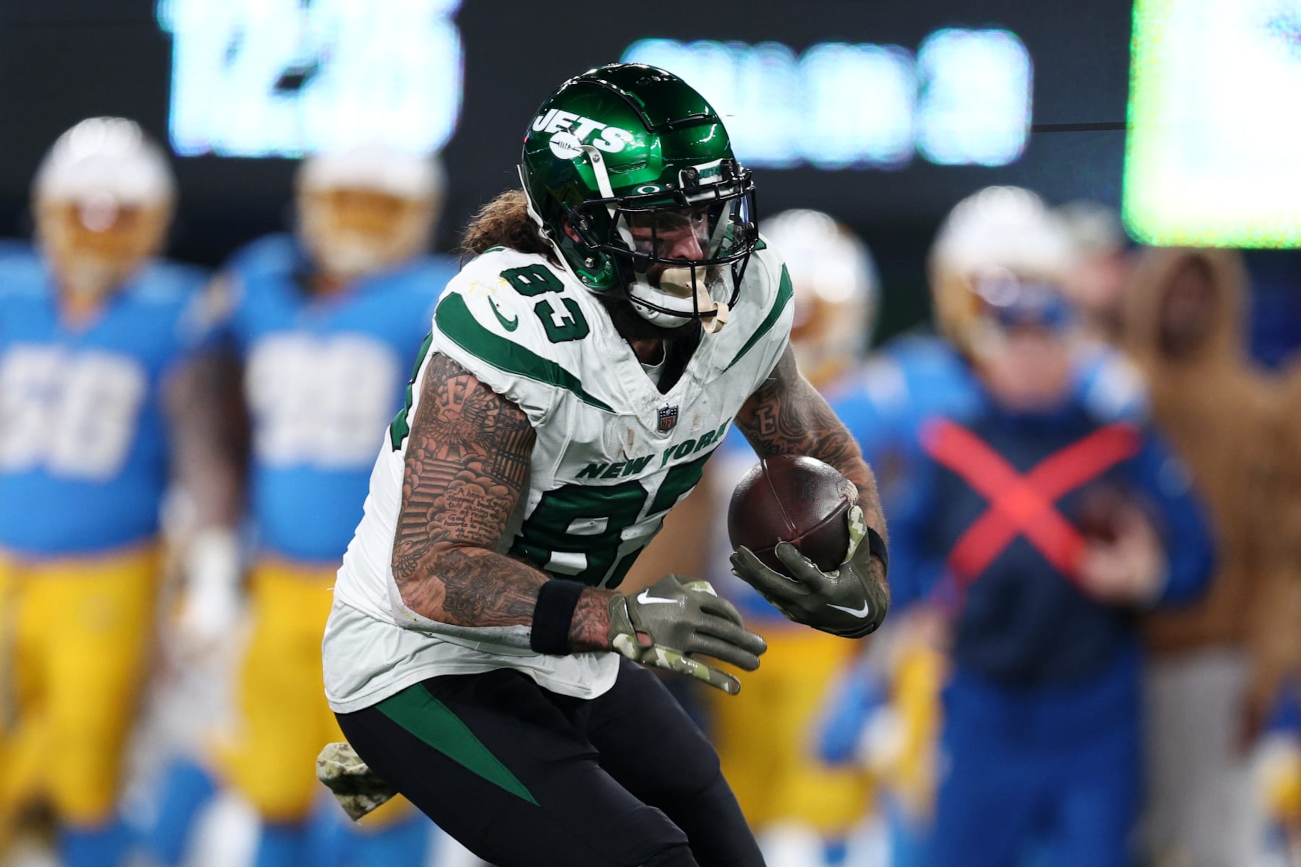 EAST RUTHERFORD, NEW JERSEY - NOVEMBER 06: Tyler Conklin #83 of the New York Jets runs with the ball during the second half against the Los Angeles Chargers at MetLife Stadium on November 06, 2023 in East Rutherford, New Jersey. (Photo by Elsa/Getty Images)