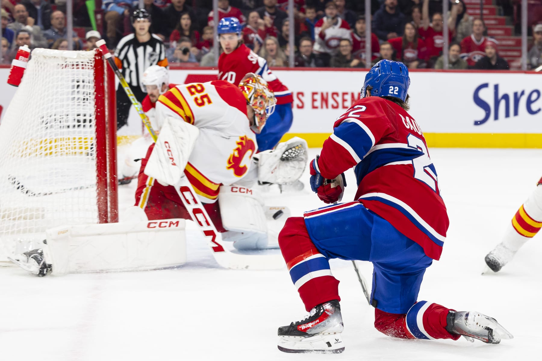 MONTREAL, CANADA - NOVEMBER 14: Jacob Markstrom #25 of the Calgary Flames makes a pad save on Cole Caufield #22 of the Montreal Canadiens during the first period of the NHL regular season game between the Montreal Canadiens and the Calgary Flames at the Bell Centre on November 14, 2023 in Montreal, Quebec, Canada. (Photo by Vitor Munhoz/NHLI via Getty Images)