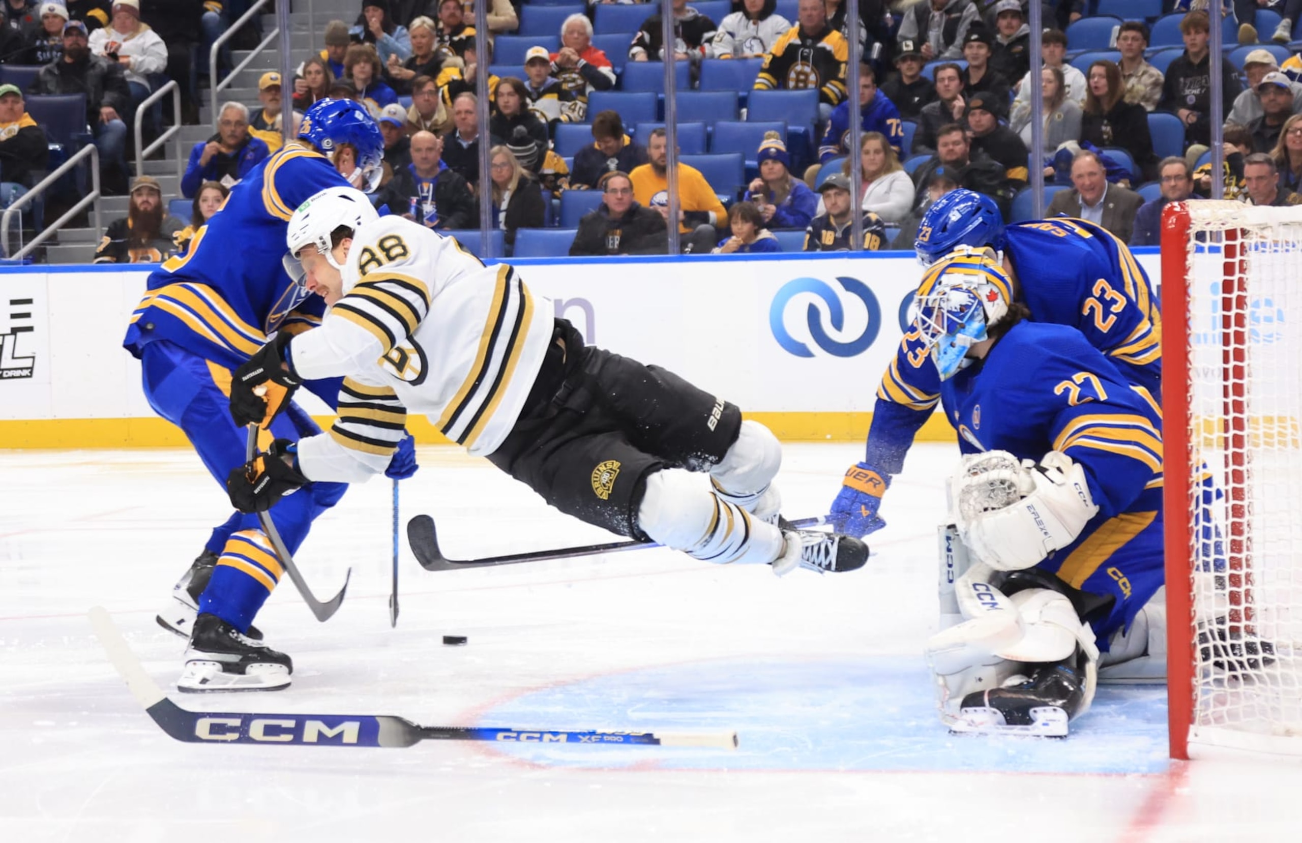 BUFFALO, NEW YORK - NOVEMBER 14: David Pastrnak #88 of the Boston Bruins is upset while battling against Rasmus Dahlin #26, Mattias Samuelsson #23 and Devon Levi #27 of the Buffalo Sabres during an NHL game on November 14, 2023 at KeyBank Center in Buffalo, New York. (Photo by Bill Wippert/NHLI via Getty Images) BUFFALO, NEW YORK - NOVEMBER 14: David Pastrnak #88 of the Boston Bruins is upset while battling against Rasmus Dahlin #26, Mattias Samuelsson #23 and Devon Levi #27 of the Buffalo Sabres during an NHL game on November 14, 2023 at KeyBank Center in Buffalo, New York. (Photo by Bill Wippert/NHLI via Getty Images)