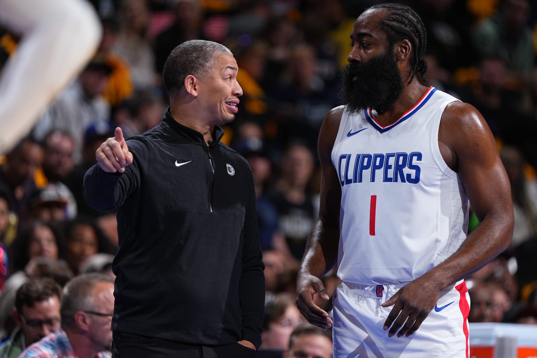 Clippers coach Ty Lue, left, and newly acquired star James Harden consult during a game.