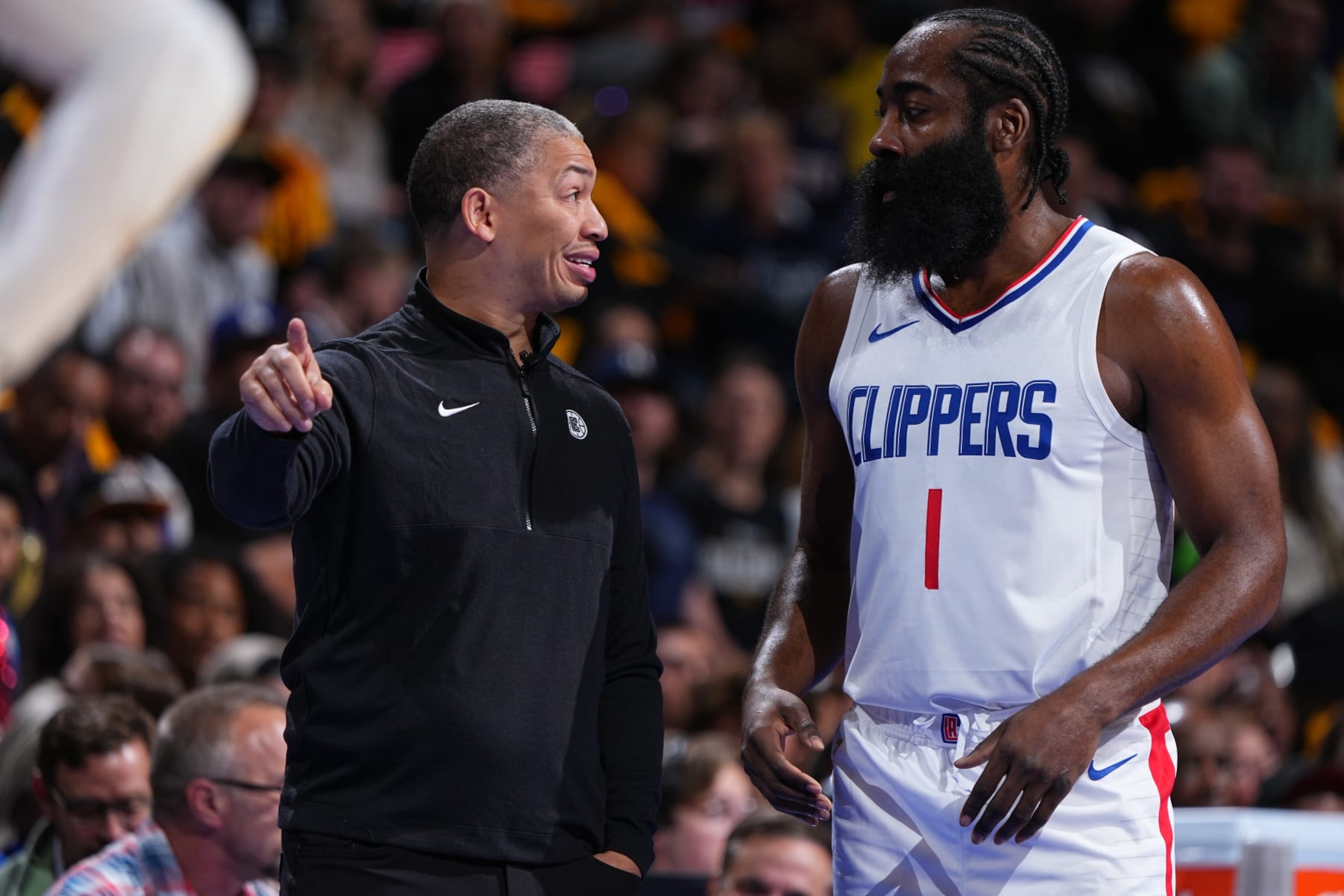 Clippers coach Ty Lue, left, and newly acquired star James Harden consult during a game.